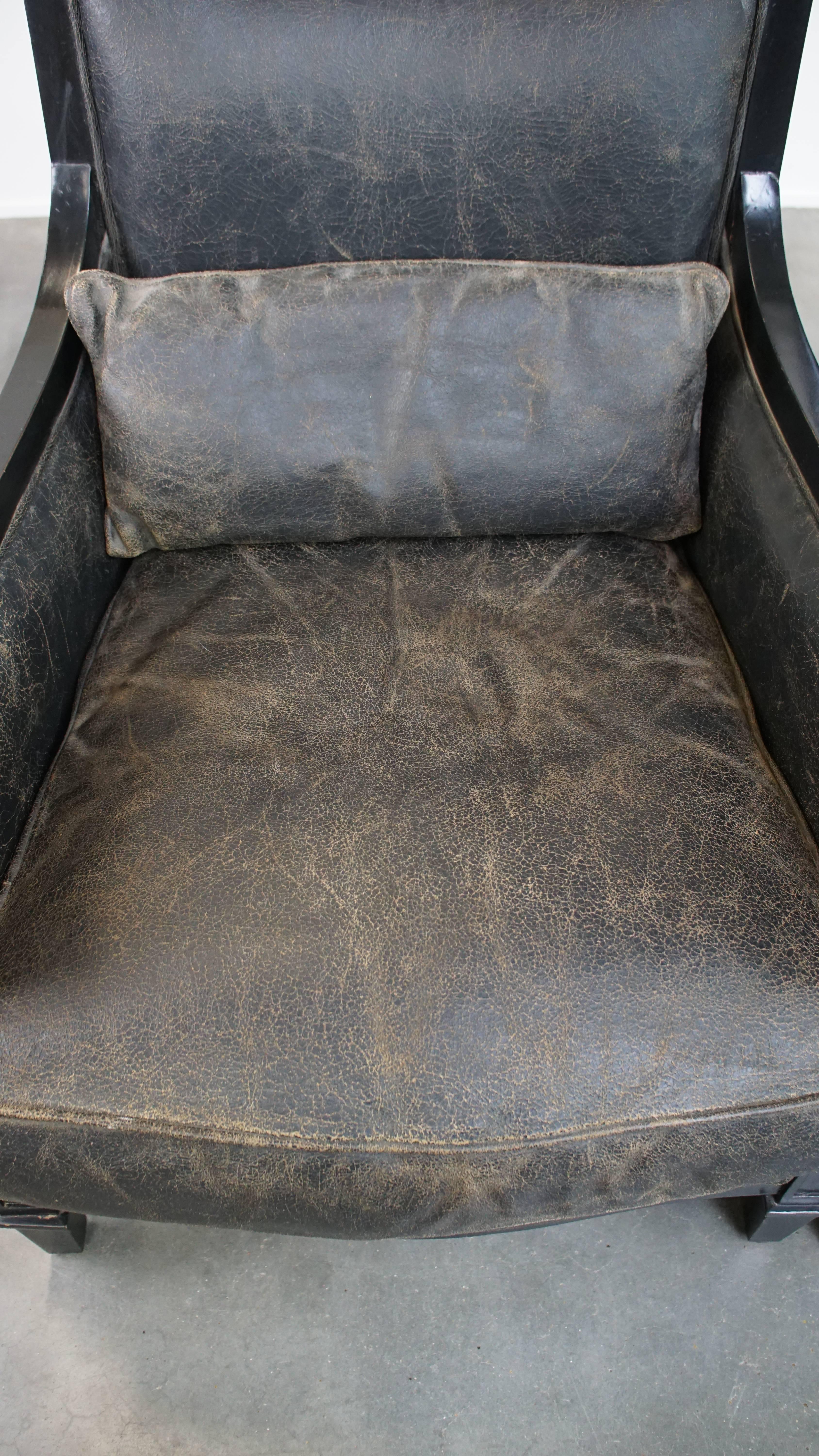 Cowhide Set of 2 black cowhide leather and wooden armchairs with an Art Deco design For Sale