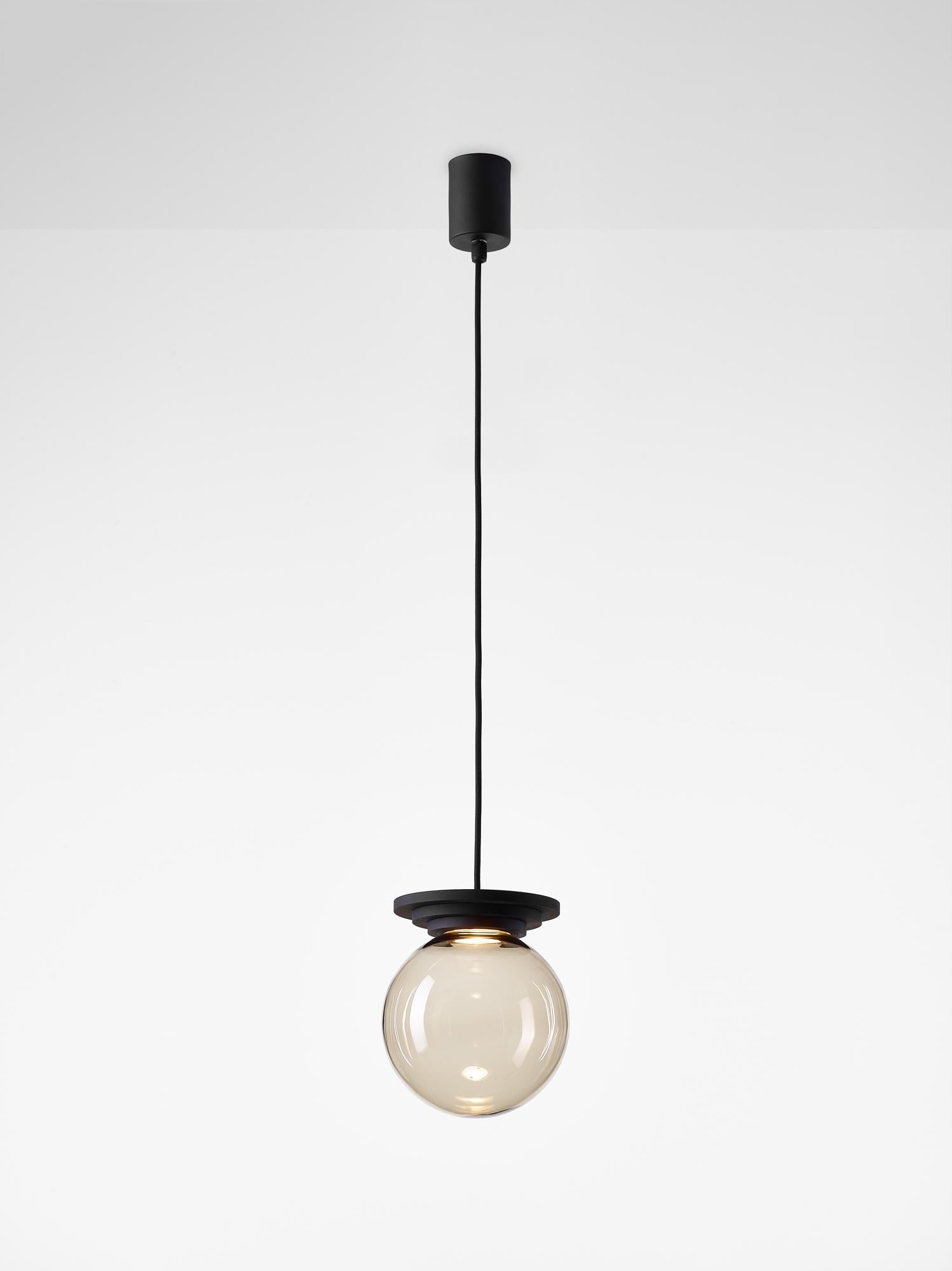 Set of 2 black stratos ball pendant light by Dechem Studio
Dimensions: D 18 x H 20 cm
Materials: Aluminum, Glass.
Also Available: Different colours available.

Different shapes of capsules and spheres contrast with anodized alloy fixtures,