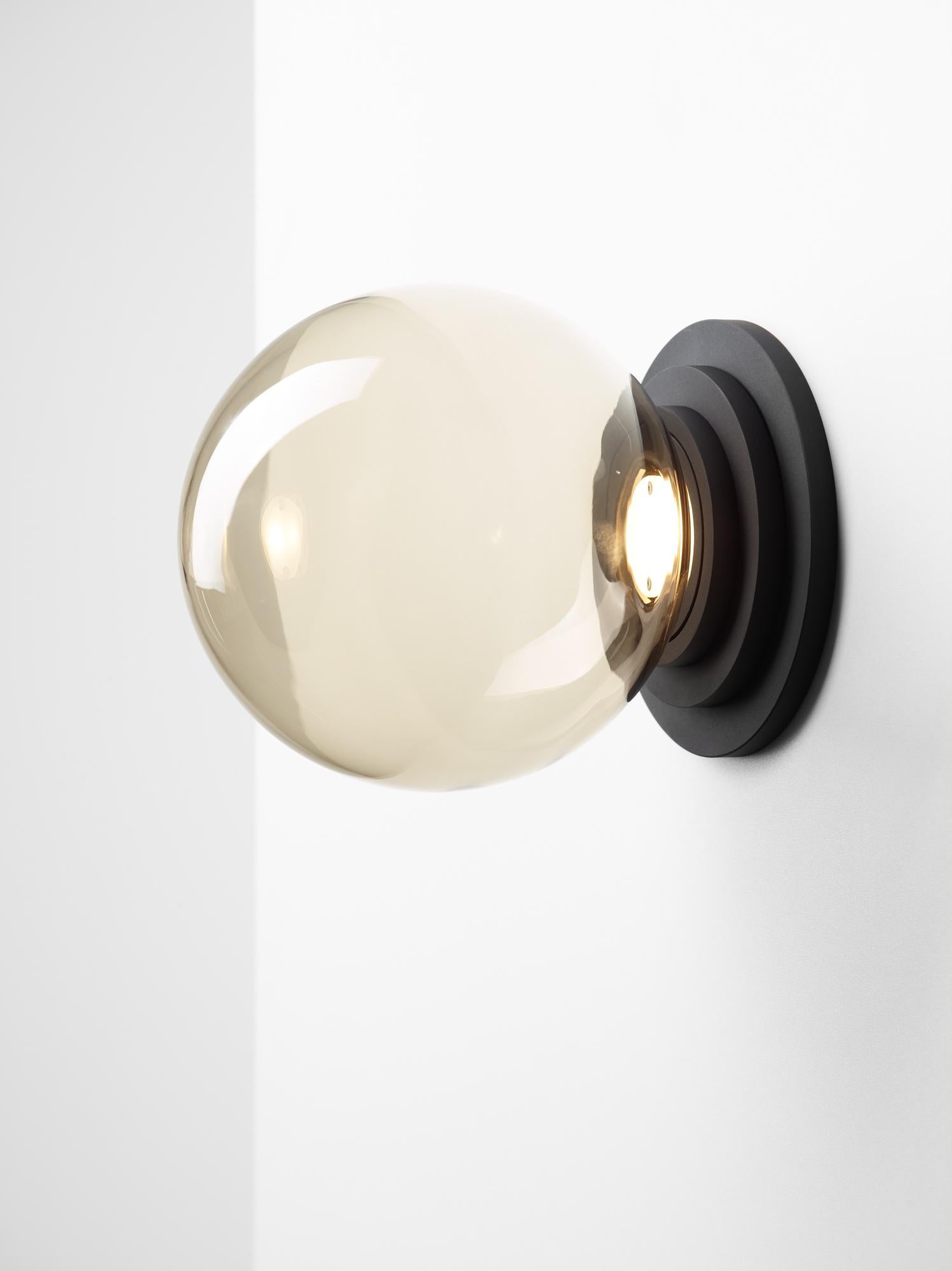 Set of 2 black stratos ball wall light by Dechem Studio.
Dimensions: D 18 x H 20 cm.
Materials: aluminum, glass.
Also available: different colours available.

Different shapes of capsules and spheres contrast with anodized alloy fixtures,