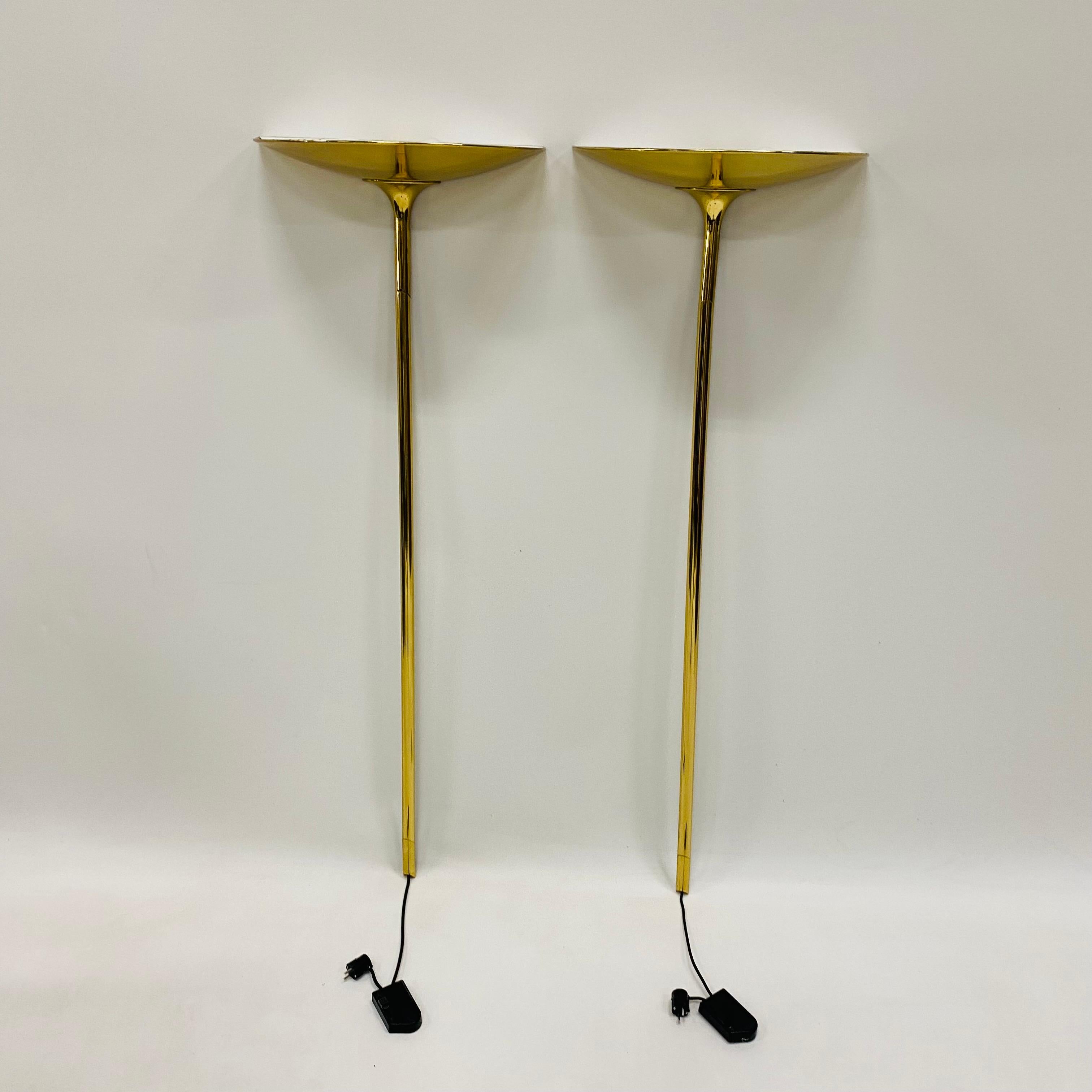 Introducing the Set of 2 Brass Wall Uplights by renowned designer Florian Schulz, crafted in Germany in the 1970s. With its exquisite mid-century design, this lighting fixture is perfect for elevating the ambiance of any luxurious setting, including