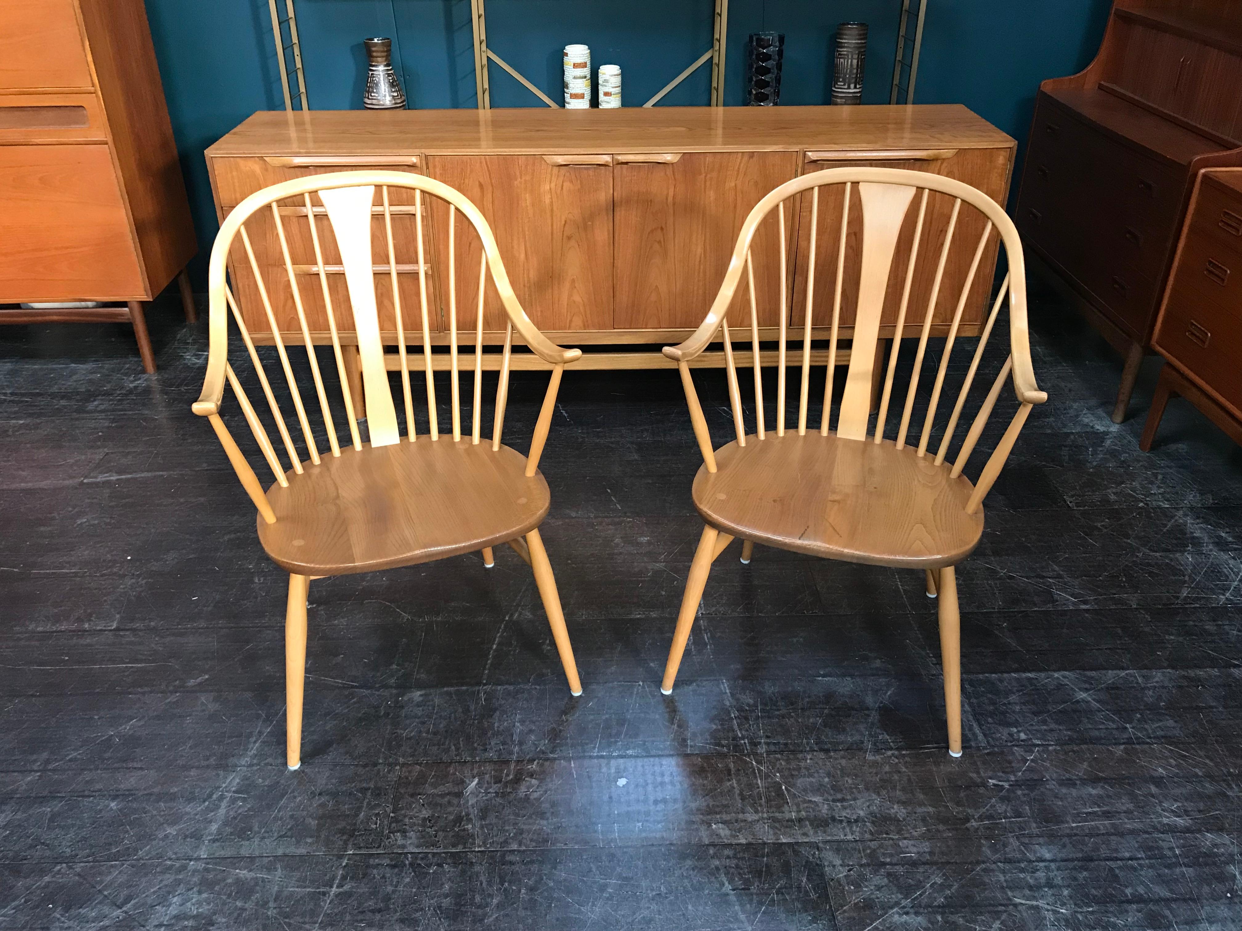 Two rare Ercol Cowhorn armchairs in sought-after light wood. Perfect for any living space, these beautiful chairs are made from solid elm and beech. They feature Ercol’s characteristic stick-back look, creating a greater sense of space and light.