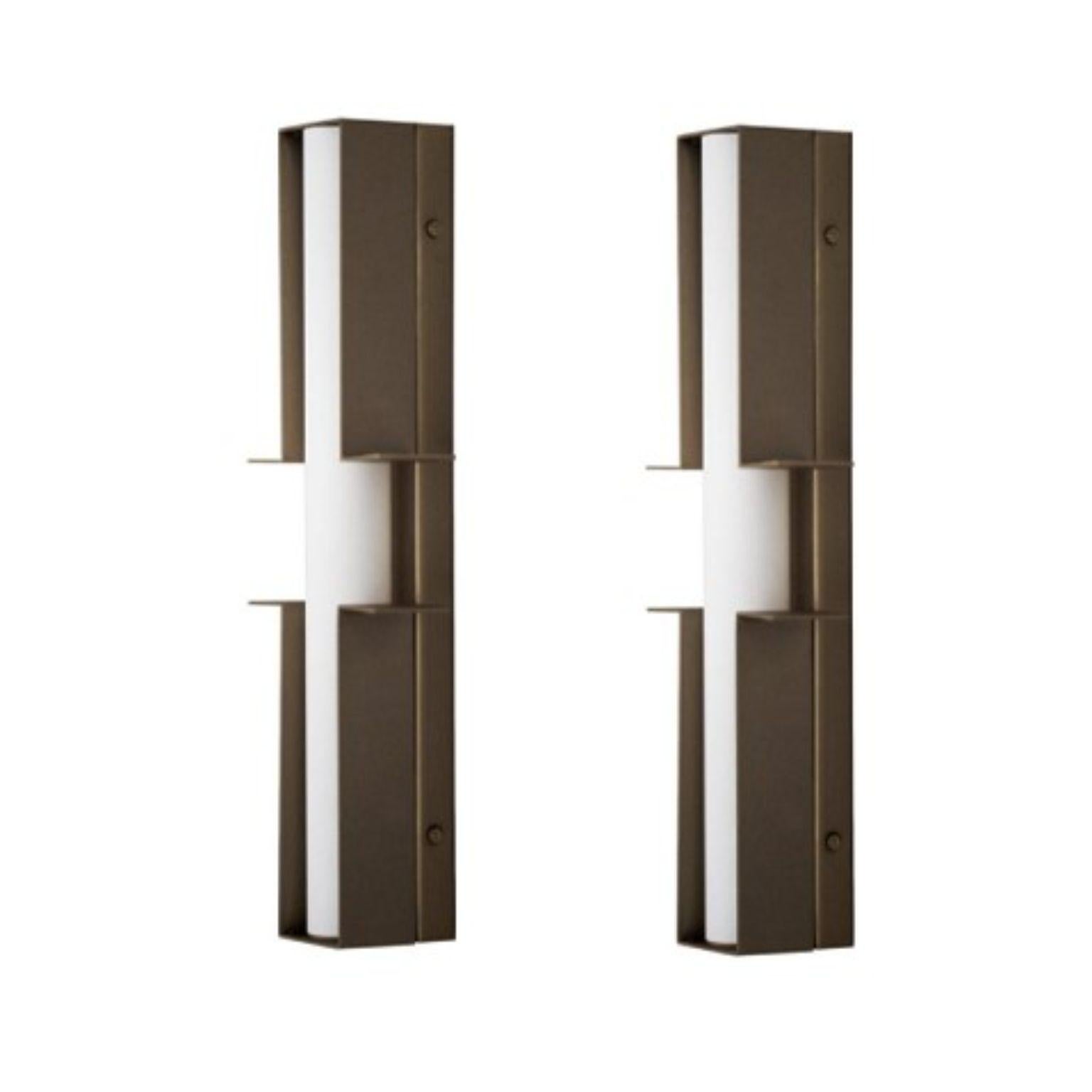 Set of 2 bronze junction wall lights by Square in Circle
Dimensions: W 12,5 x H 38 x D 6 cm
Materials: Dark bronze, white frosted glass tube 

A dark bronze wall light crafted from two parts. Each part extends to the sides, creating a minimalist