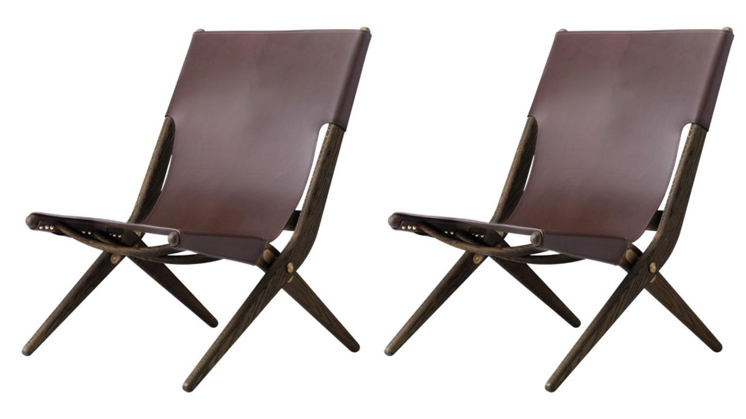 Set of 2 brown stained oak and brown leather Saxe chairs by Lassen
Dimensions: W 60 x D 67 x H 84 cm 
Materials: leather, oak.

Mogens Lassen was perceived as ‘the naughty boy in class’, but he aimed for perfection in each design project. His