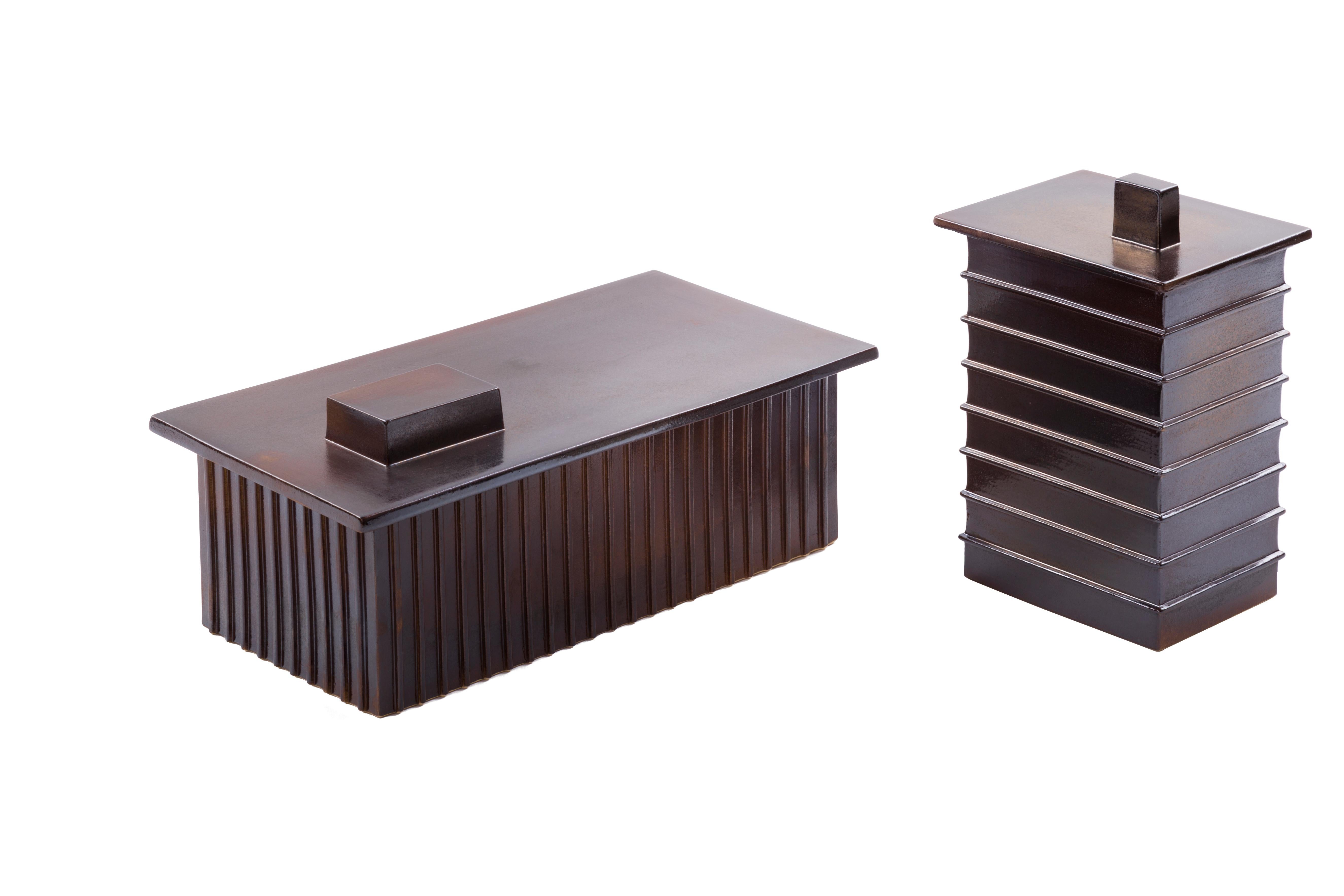 Set of 2 building boxes by Pulpo
Dimensions: D32.5 x W17 x H13 cm / D14.5 × W11.5 × H23.5 cm
Materials: Ceramic

Also available in different colours. 

This building boxes bring to mind the Industrial areas so familiar within our urban