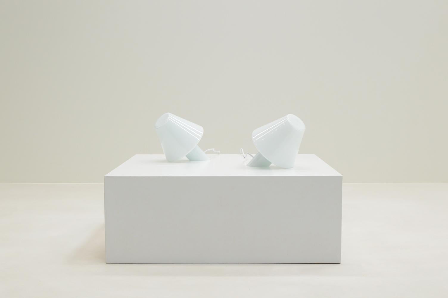 Set of 2 “Bye Bye” table lamps by Menno Dieperink, 1990s The Netherlands. A querky interpretation of a traditional shade lamp. The set would also work well as bedside lights. The lamps were produced under own management. Fully made of white glass