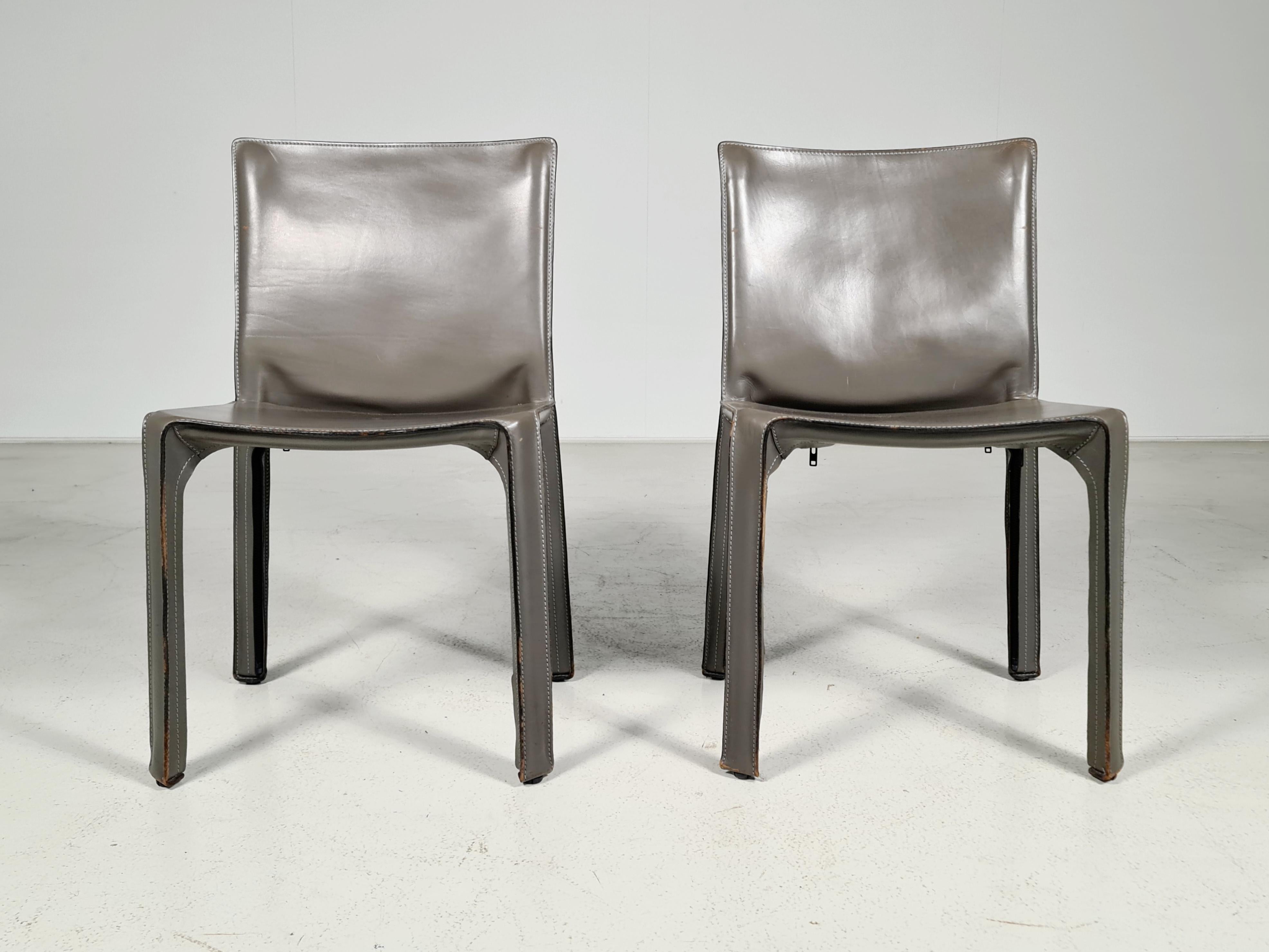 Set of 2 CAB-412 dining room chairs in Elephant grey saddle leather. Designed by Mario Bellini and manufactured by Cassina in the 1970s in Italy. These chairs are the early edition. The leather cover is stretched over a minimal tubular steel frame.