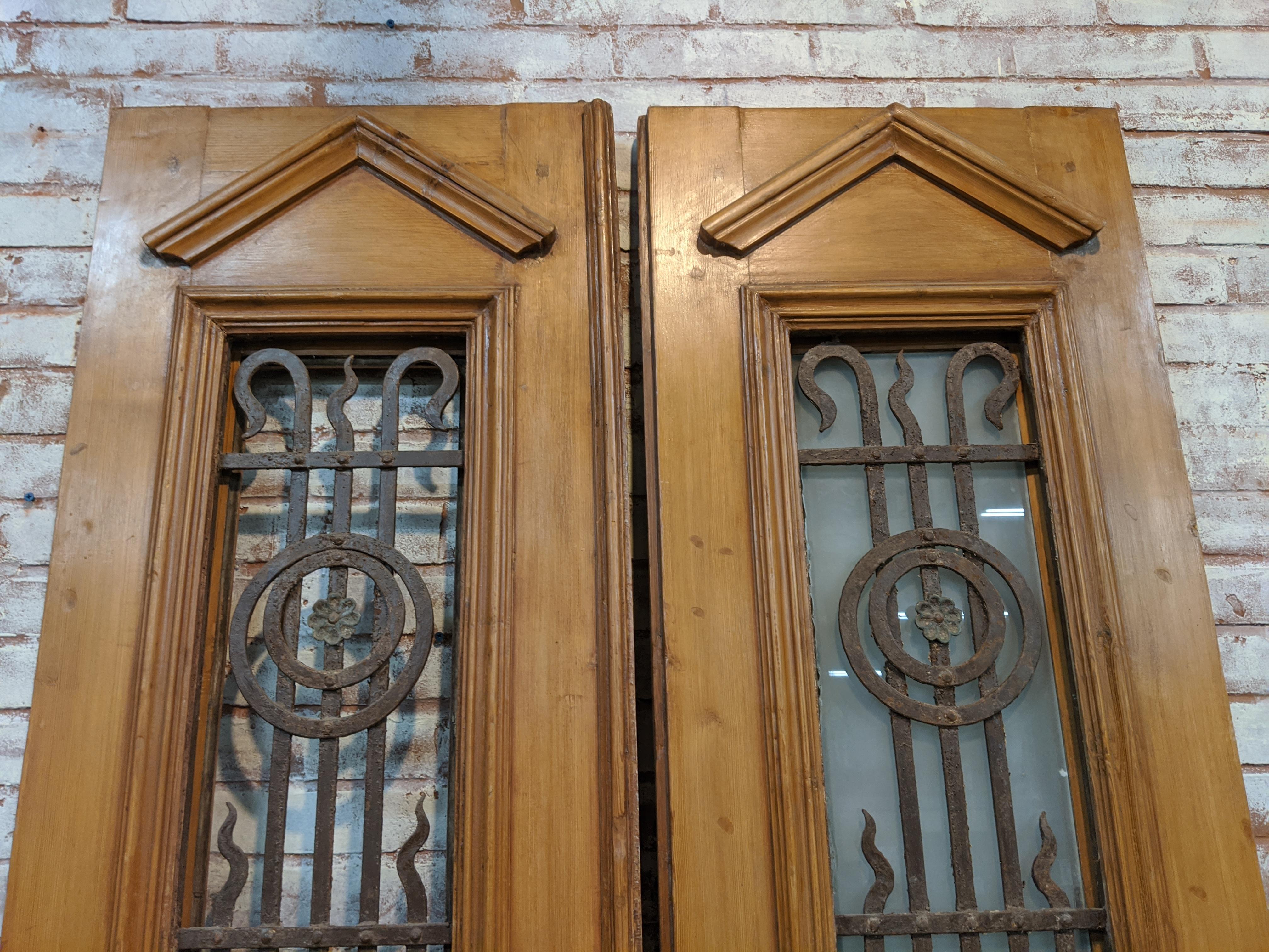 Pair of vintage doors from Egypt. All paint has been removed and doors have a waxed finish. Original ironwork also cleaned. Each door measures 20