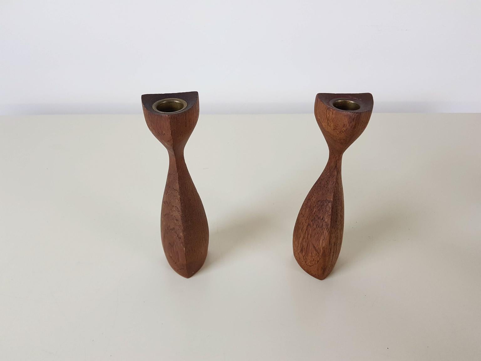 A pair of two carved teak candleholder, stands or sticks with nice organic shapes made in Denmark in the 1950s. Inside the candleholder there is a brass ring to hold the candle and protect the teak wood.

This item comes with free delivery to