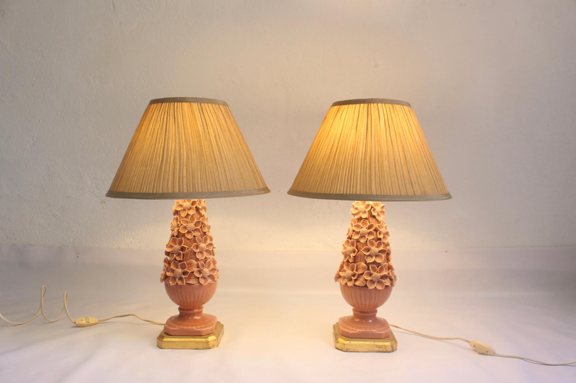 Set of 2 handmade pink/salmon ceramic table lamps, Manises, Valencia, Spain. Gilded wooden bases and new fabric shades hand-sewing, also made in Spain at the time but, brand new, never used before. Pictures with 3 different intensity bulbs.