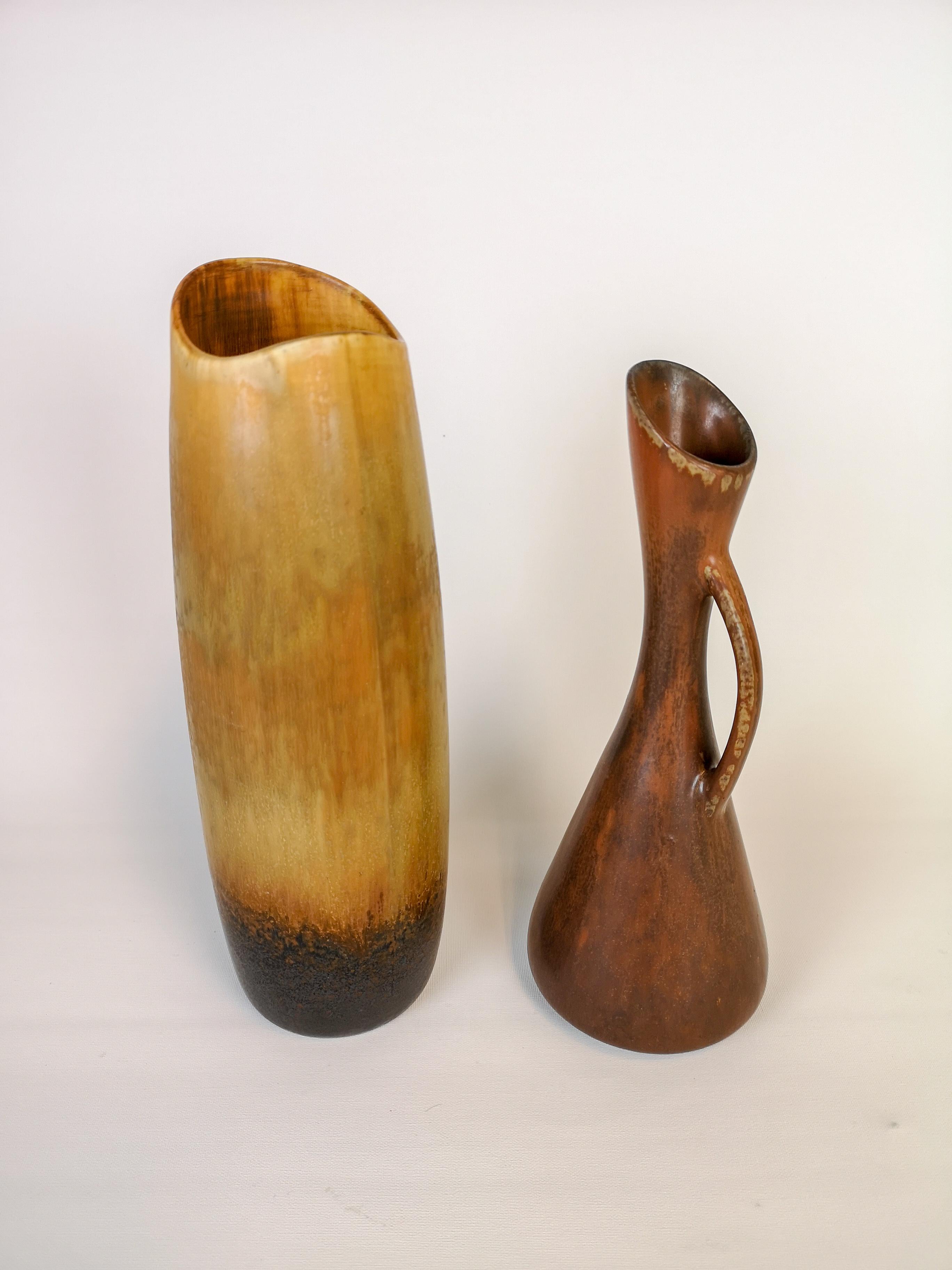 These two vases were made in Sweden in the 1950s at Rörstrand and designed by Gunnar Nylund. 
They are both beautiful in there shifting glaze color and stunning forms. 

Good condition. 

Measures: H 27 cm, D 10 cm and H 24 cm, D 10 cm.
 
