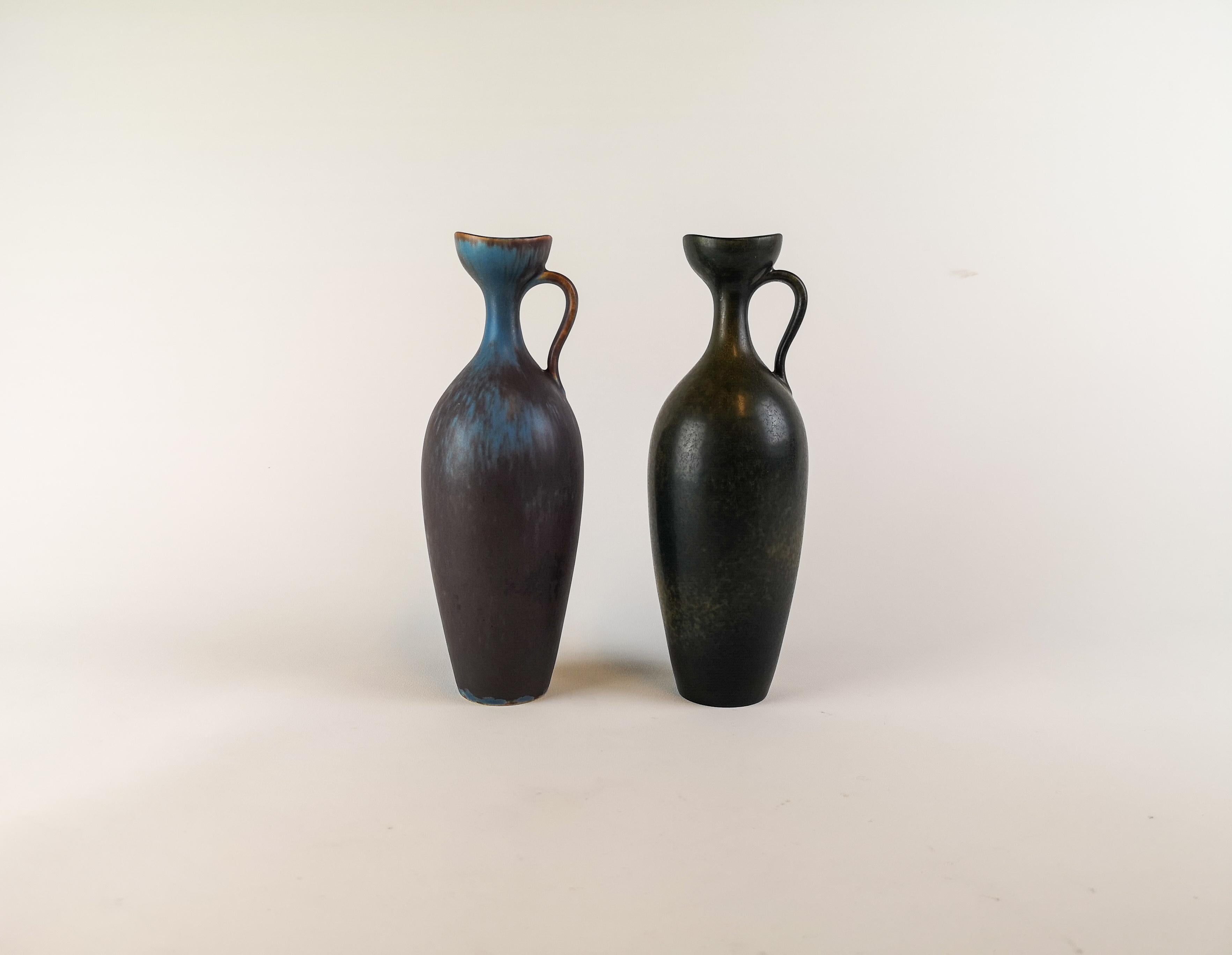 Two wonderful ceramic vases made in Sweden during the 1950s at Rörstrand factory and designed by Gunnar Nylund.

The vases matches each other and gives a clean and modern look. They are nicely sculptured and have a nice glaze.

Good condition.