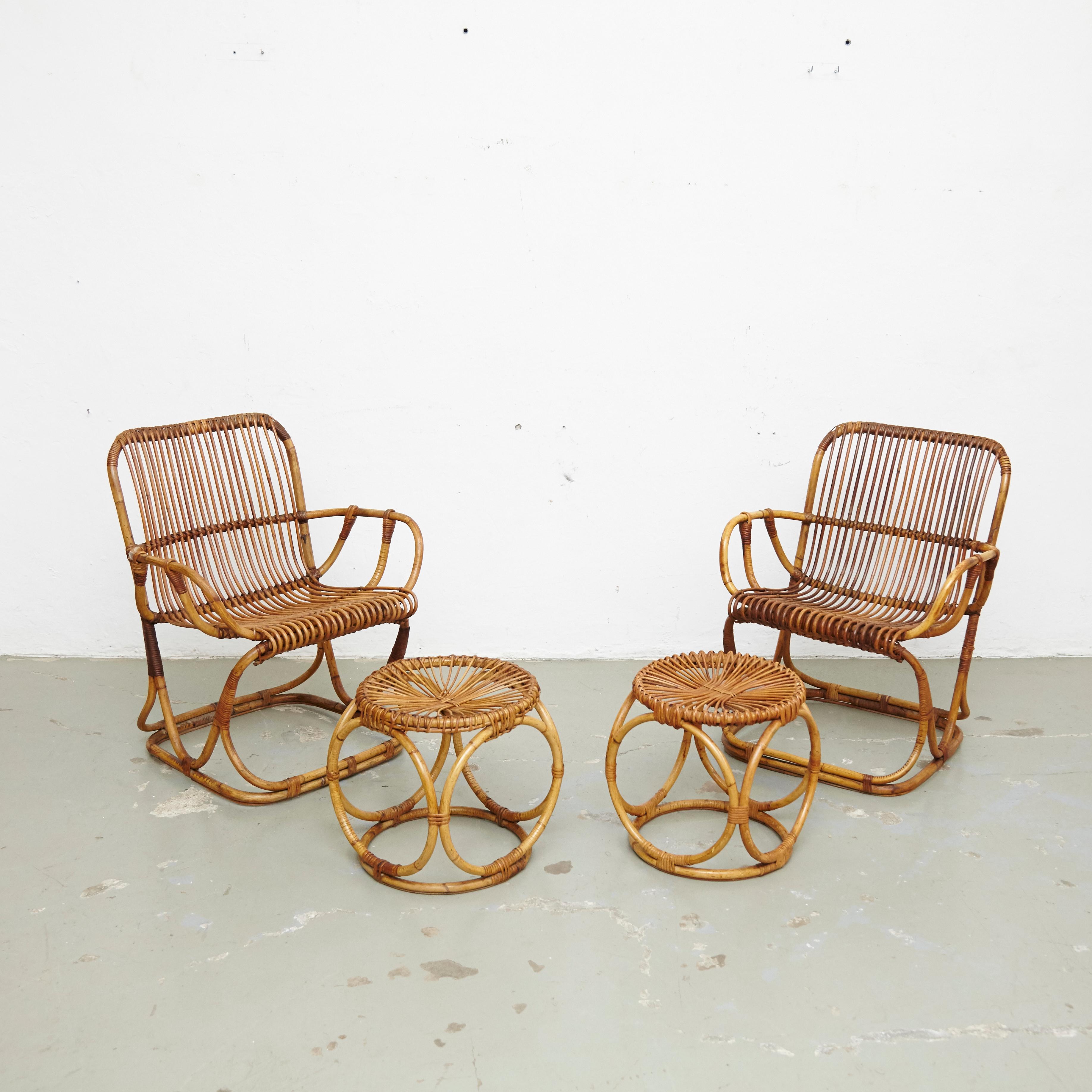 Set of two armchairs and two stools.
Manufactured in Italy, circa 1960.

In good original condition with minor wear consistent with age and use.

Materials:
Bamboo

Dimensions:
Armchair: D 65 cm x W 65 cm x H 78 cm.
Stool: D 36 cm x W 36