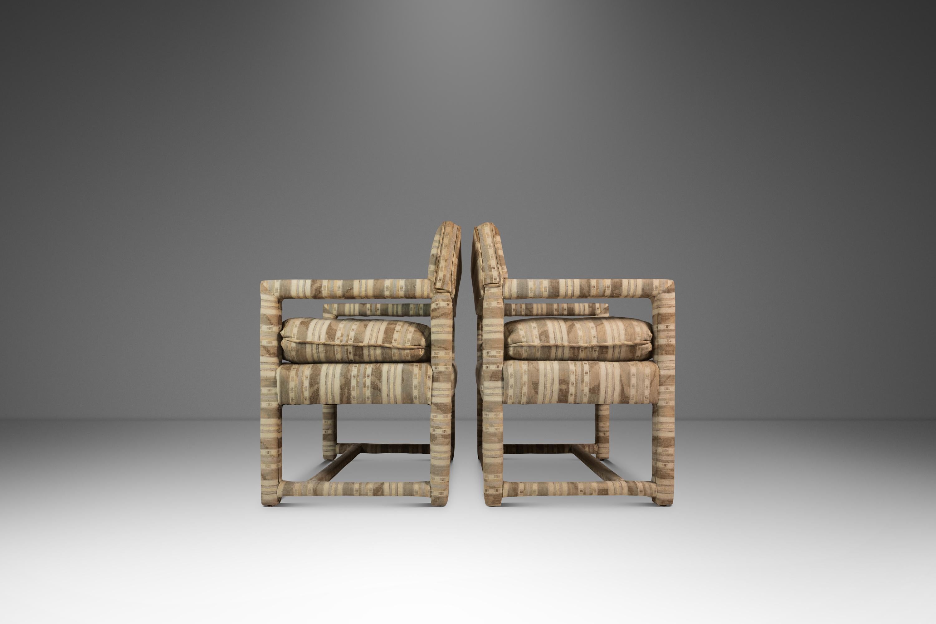 This elegant set of two Mid-Century Modern Parsons chairs, attributed to the iconic designer Milo Baughman, showcases the refined simplicity of 1960s American design. Crafted with clean, architectural lines, the chairs feature a rectangular frame