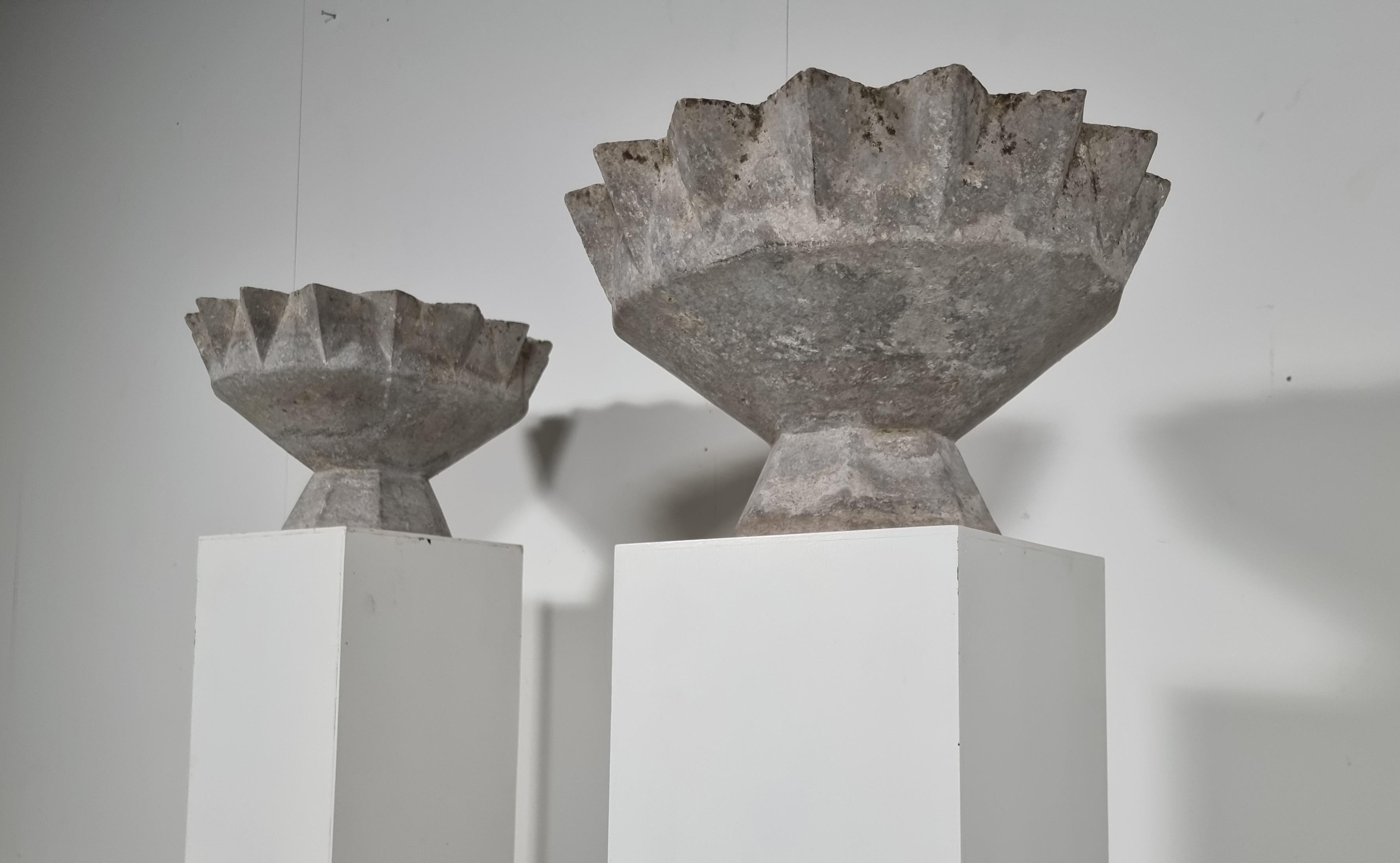 A unique set of 2 concrete planters by Swiss architect Willy Guhl. Planter in the shape of a chalice.  Signed 1972.

 This shape is not common and hard to find. Great patina. Would make a lovely planter inside or out. 

1 platner has a crack but it