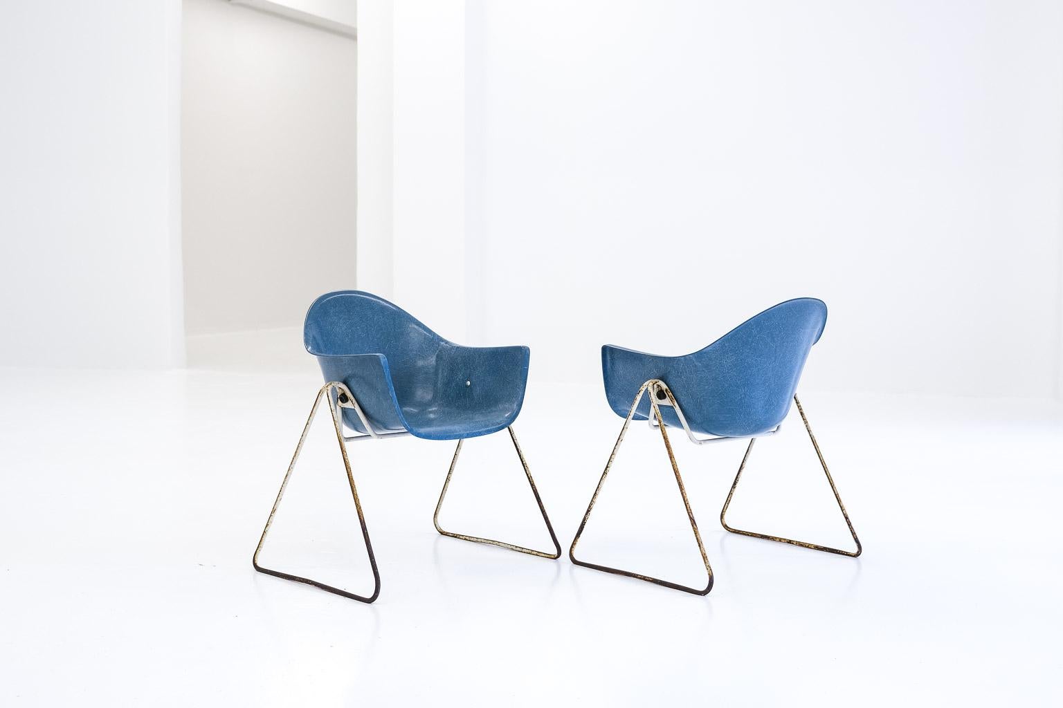 set for 2 children chairs 2015 by walter papst for wilkhahn. blue fiberglas and white steel tube frame with a distinct patina. 

here comes the whole story: 

„the harmonious design of this furniture makes the child familiar with good form from an