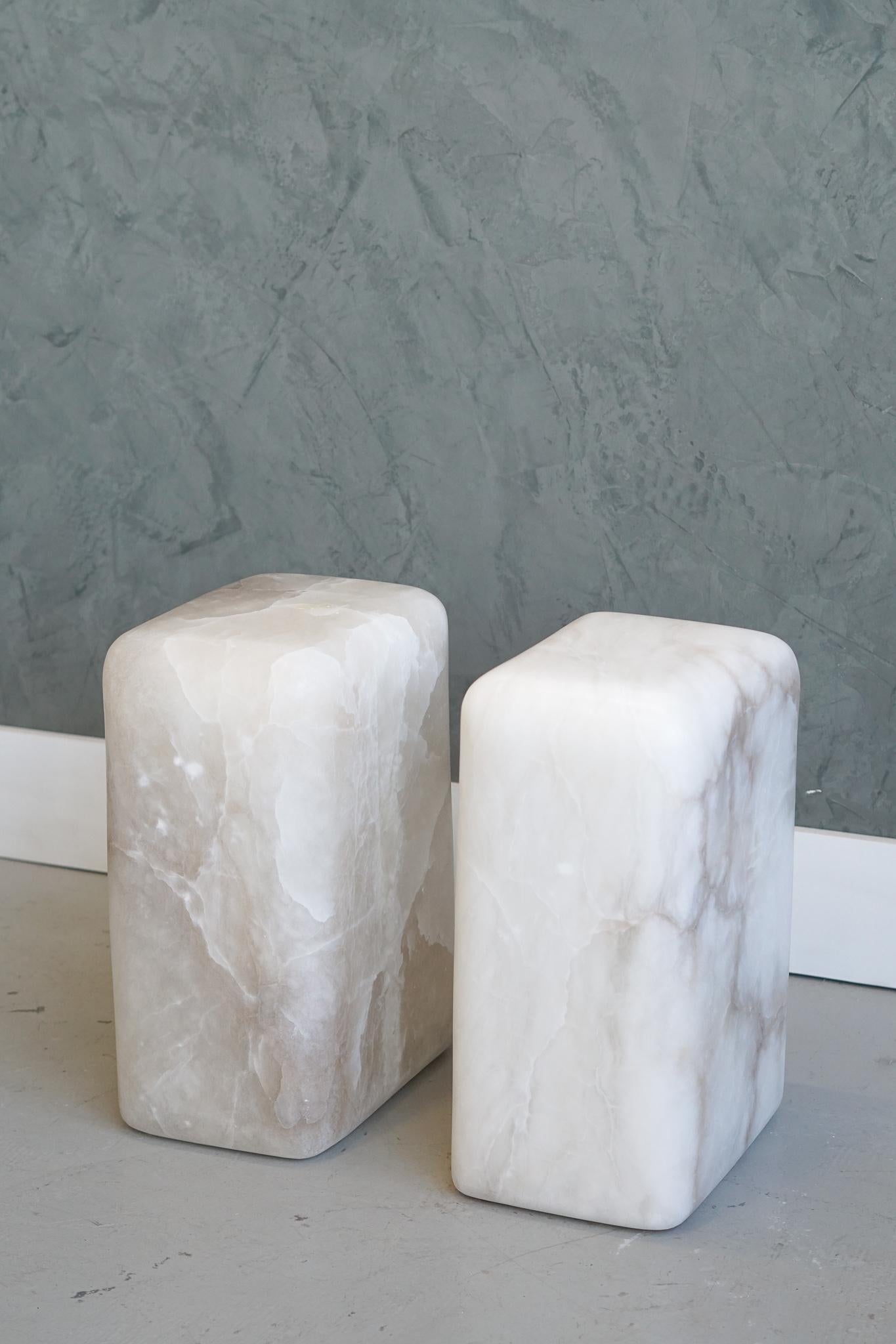 Set of 2 chunk side tables by Swell Studio
Dimensions: D31 x W26 x H46 cm 
Material: White alabaster, Breccia Stazzema


Hand shaped from a solid block of stone. The unique coloration and veining in the blocks are the focal point of this simple