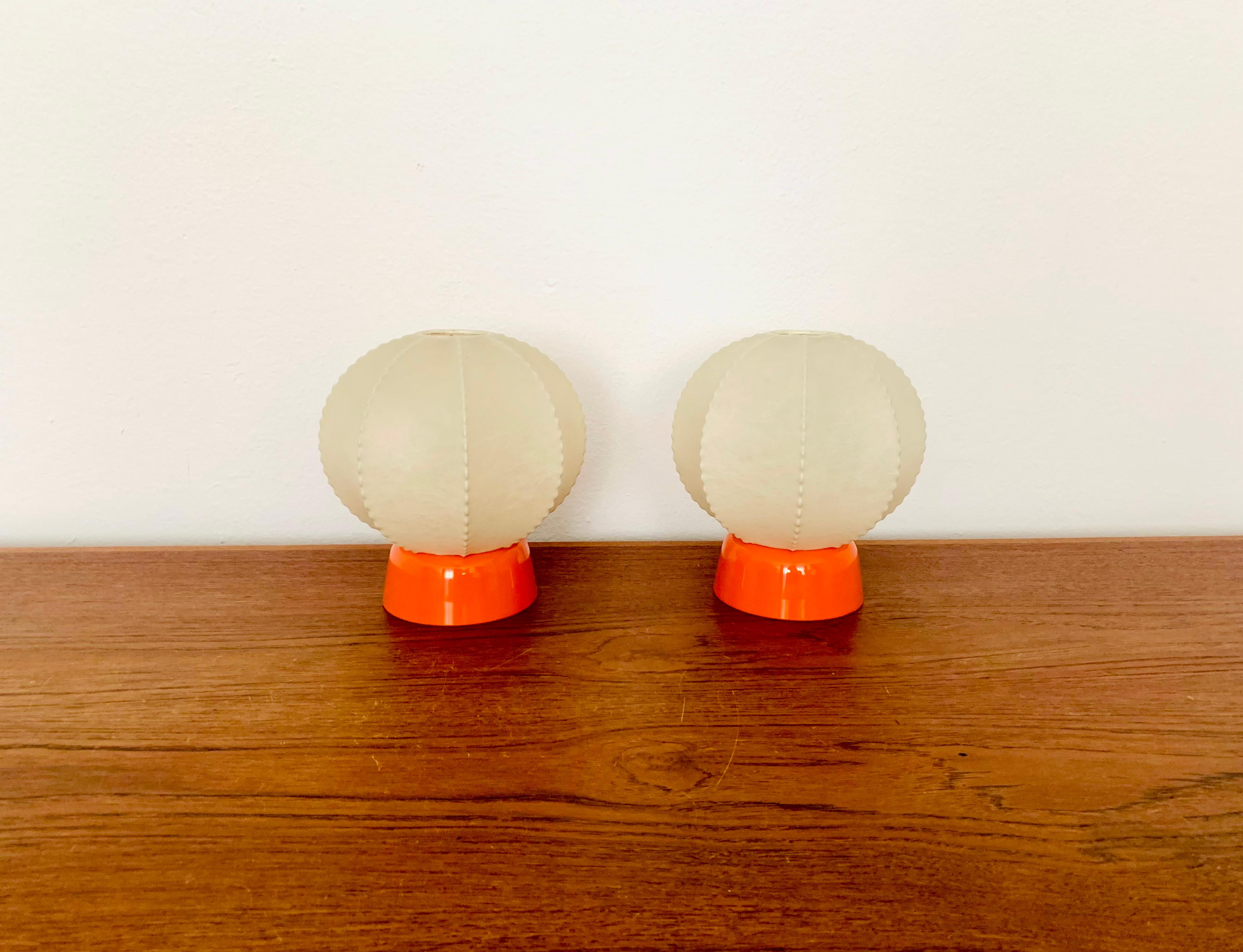 Very nice pair of small Cocoon table lamps from the 1950s.
The beautiful structure creates a warm and very cozy light.
Wonderful design and an asset to any home.

Condition:

Very good vintage condition with slight signs of wear consistent