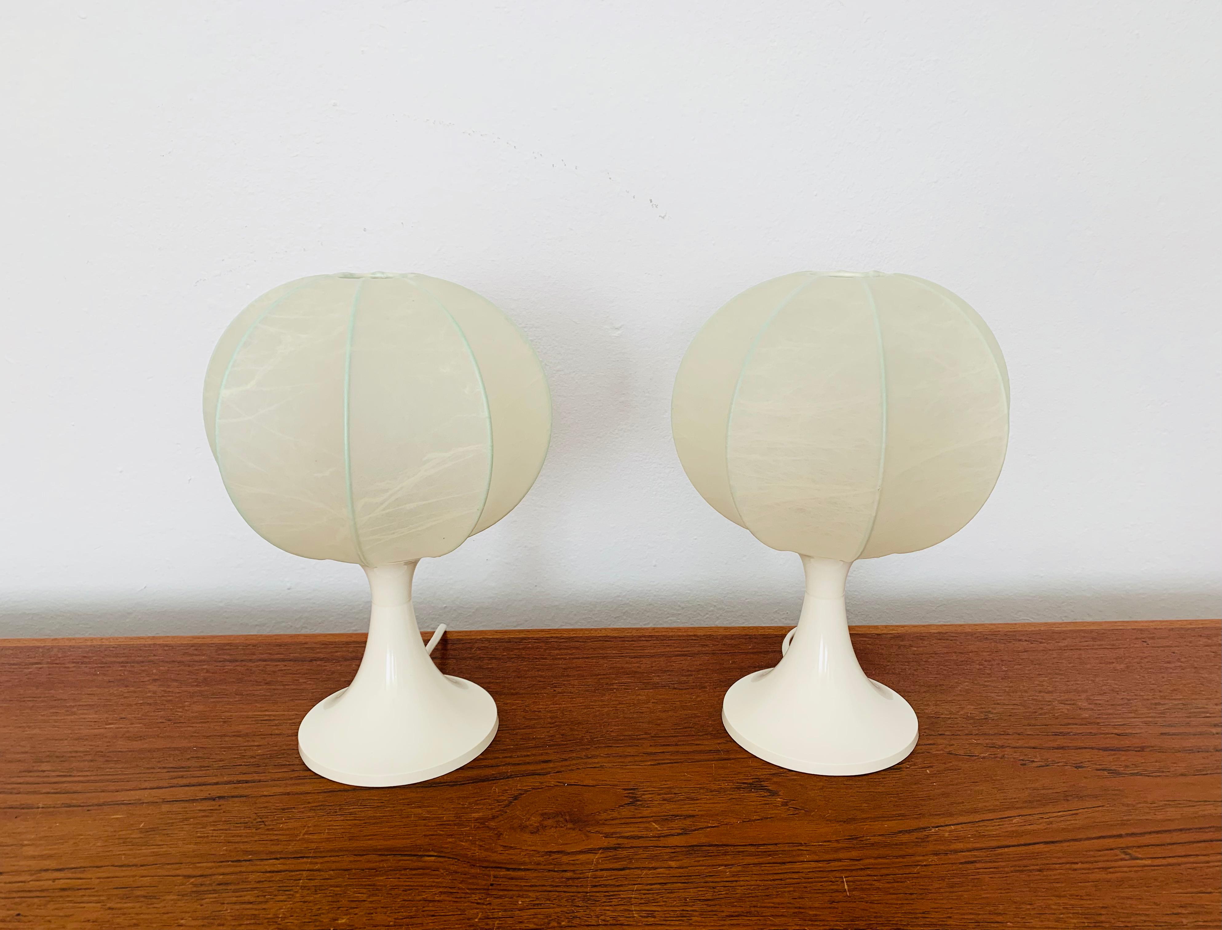 Very nice pair of small Cocoon table lamps from the 1950s.
The beautiful structure creates a warm and very cozy light.
Wonderful design and an asset to any home.

Condition:

Very good vintage condition with slight signs of wear consistent