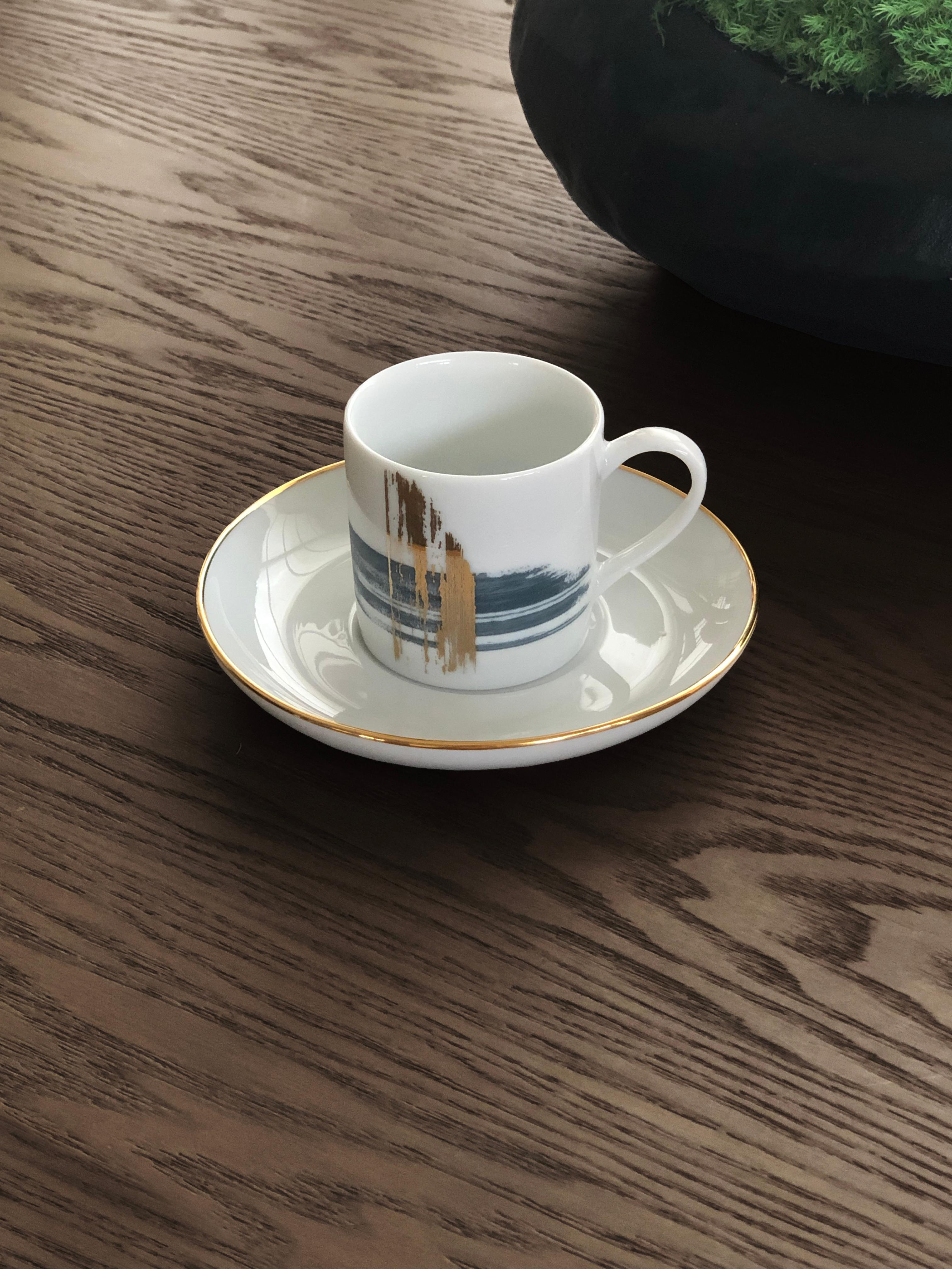Larger quantities available upon request, with 8 weeks production time.

Description: Coffee cup with saucer (2 pieces)
Color: Blue and gold
Size: 5.5Ø x 5.5H cm, 80 ml
Material: Porcelain and gold
Collection: Artisan Brush