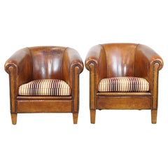 Set of 2 cognac-colored sheepskin club chairs with colorful fabric seat cushions