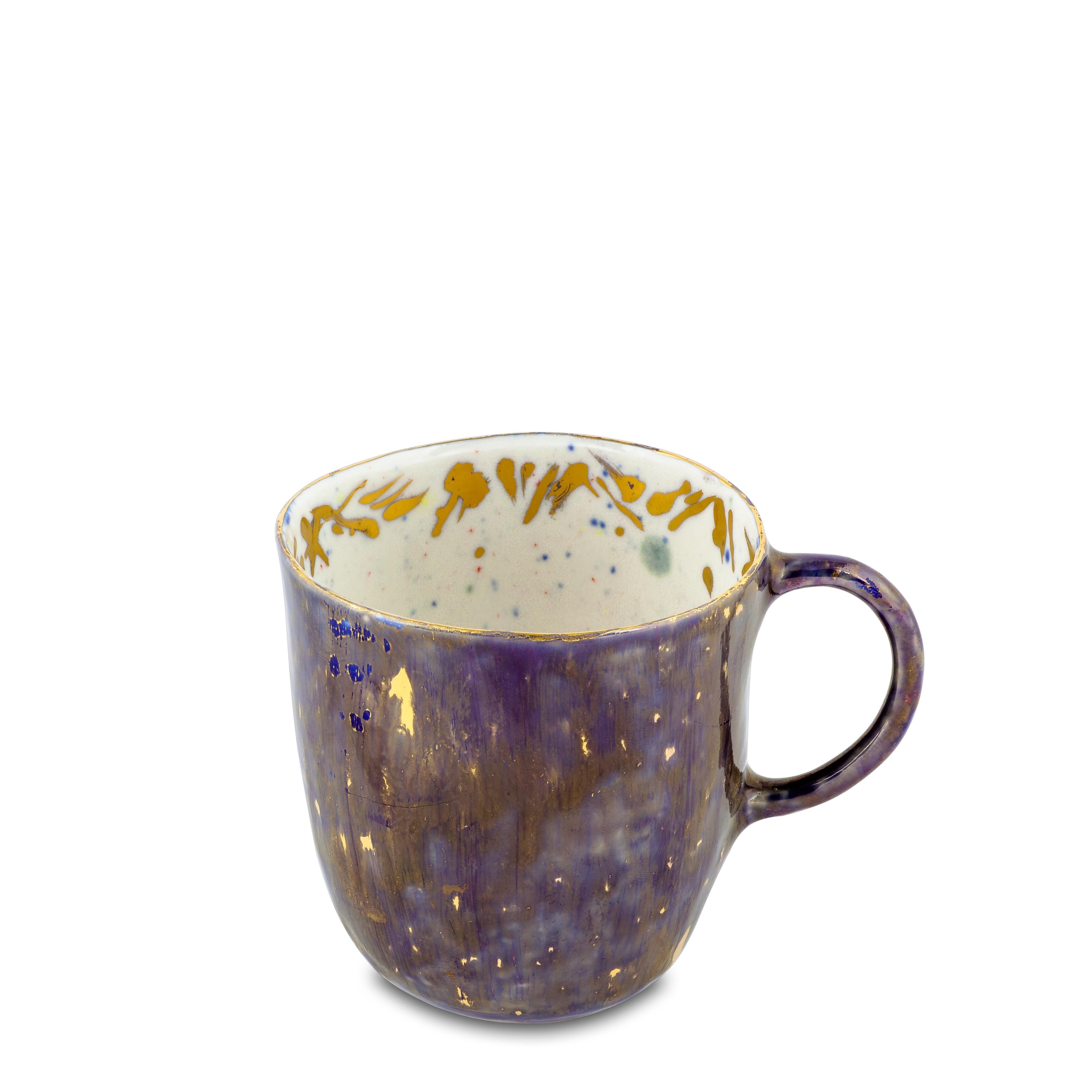 Handcrafted in Italy from the finest porcelain, Coralla's mugs are of her own design and a symbol of her work. Outside, this Apollo Bianco Coralla's Mug has a deep blue décor enriched by golden nuggets, like a starry night; the inside is painted in