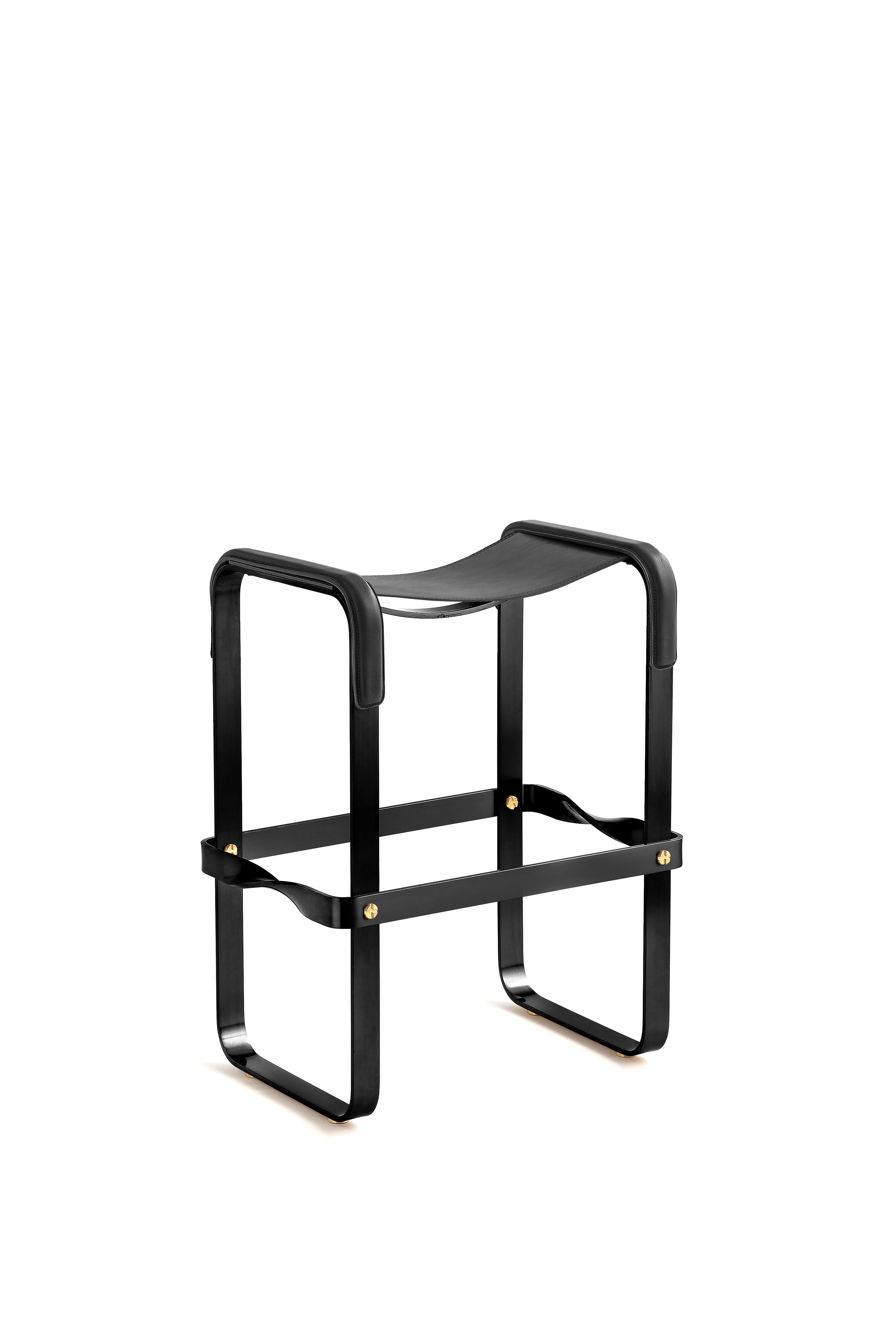 Counter stool in black smoke polished steel and black saddle leather.

The phrases 