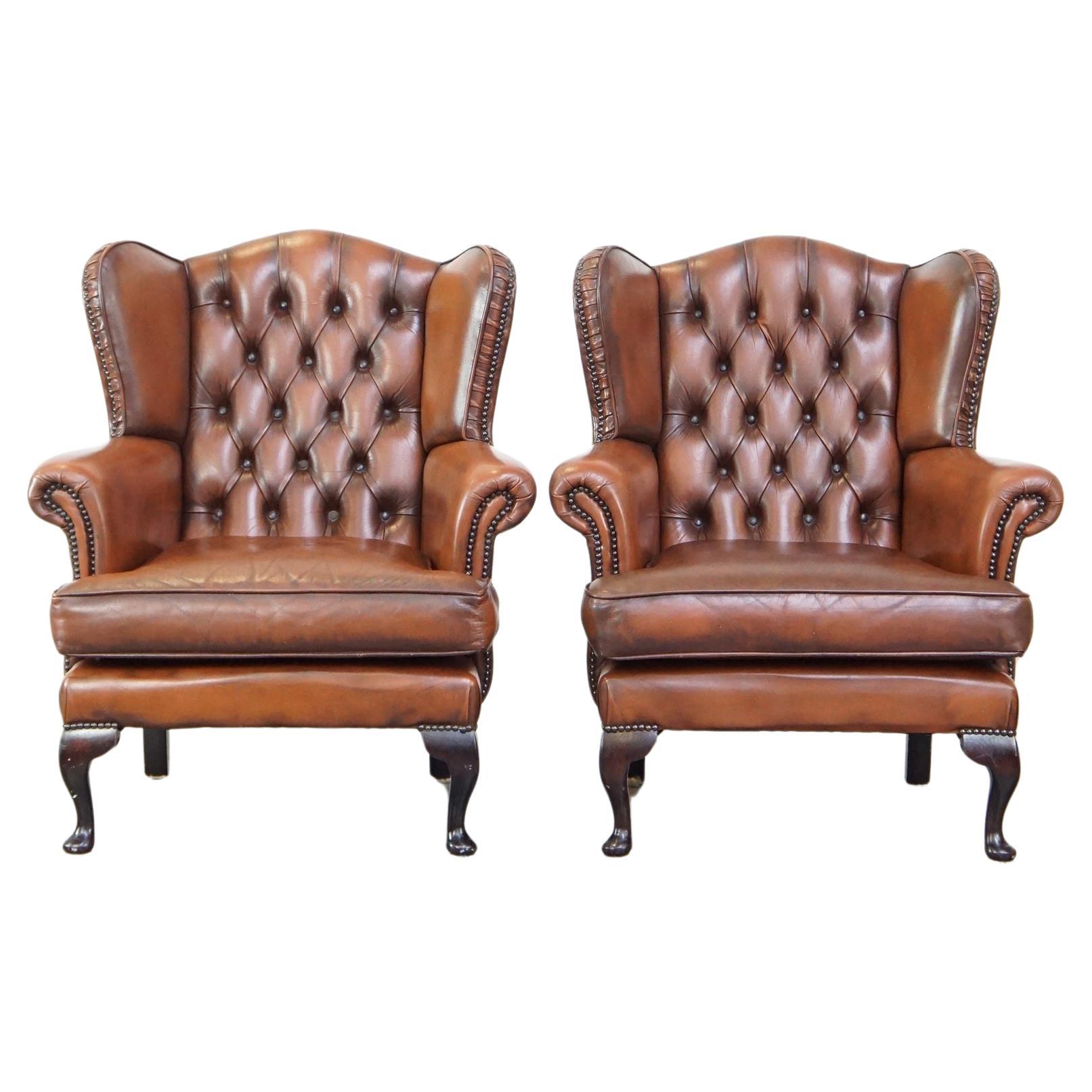 Set of 2 cowhide Chesterfield wing chairs with elegant legs in brown ...