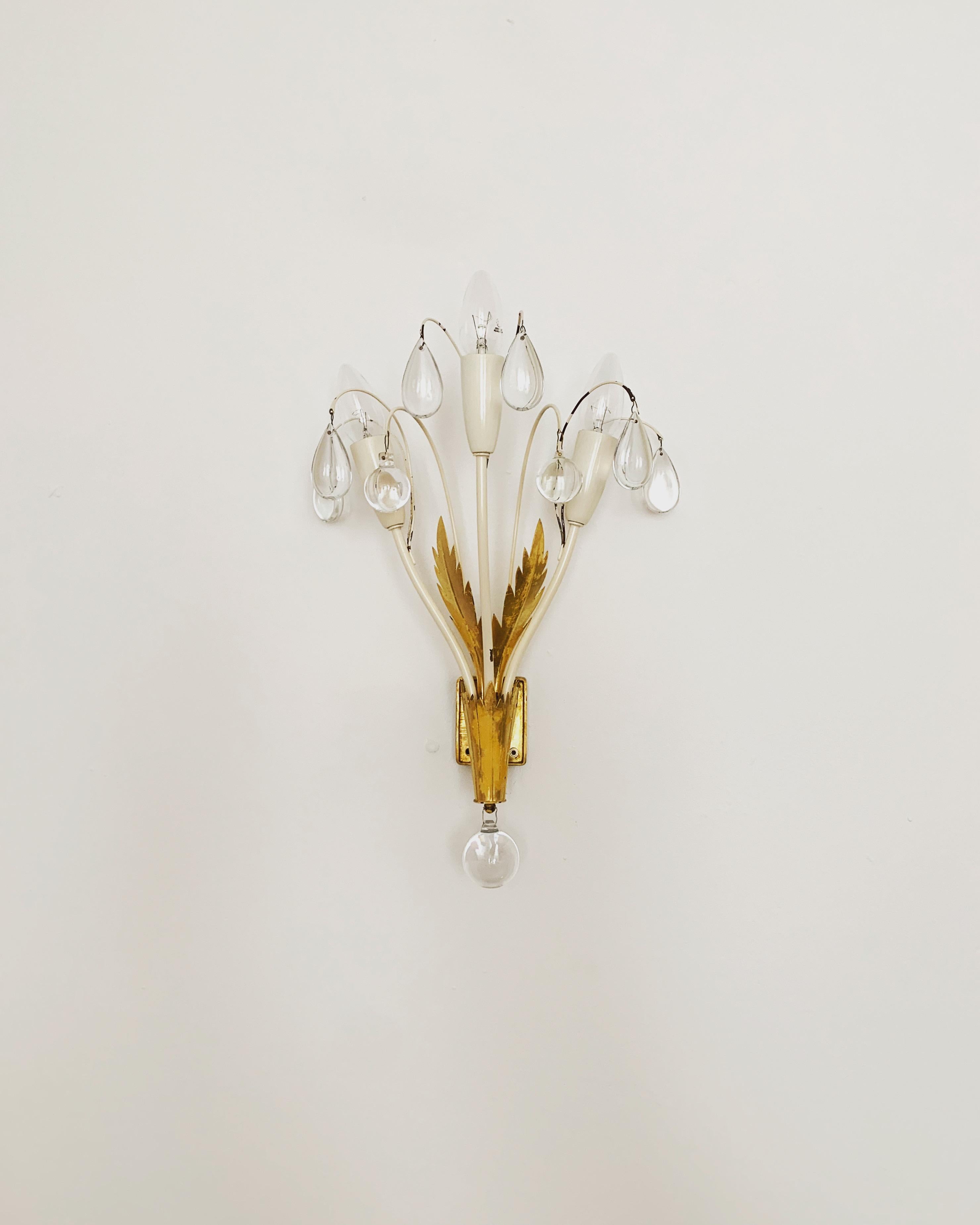 Extremely beautiful wall lamps from the 1950s.
The high-quality workmanship and the very noble material impress at first sight.
Exceptionally beautiful design.
The sparkling stones spread a sensational light.

Manufacturer: Vereinigte