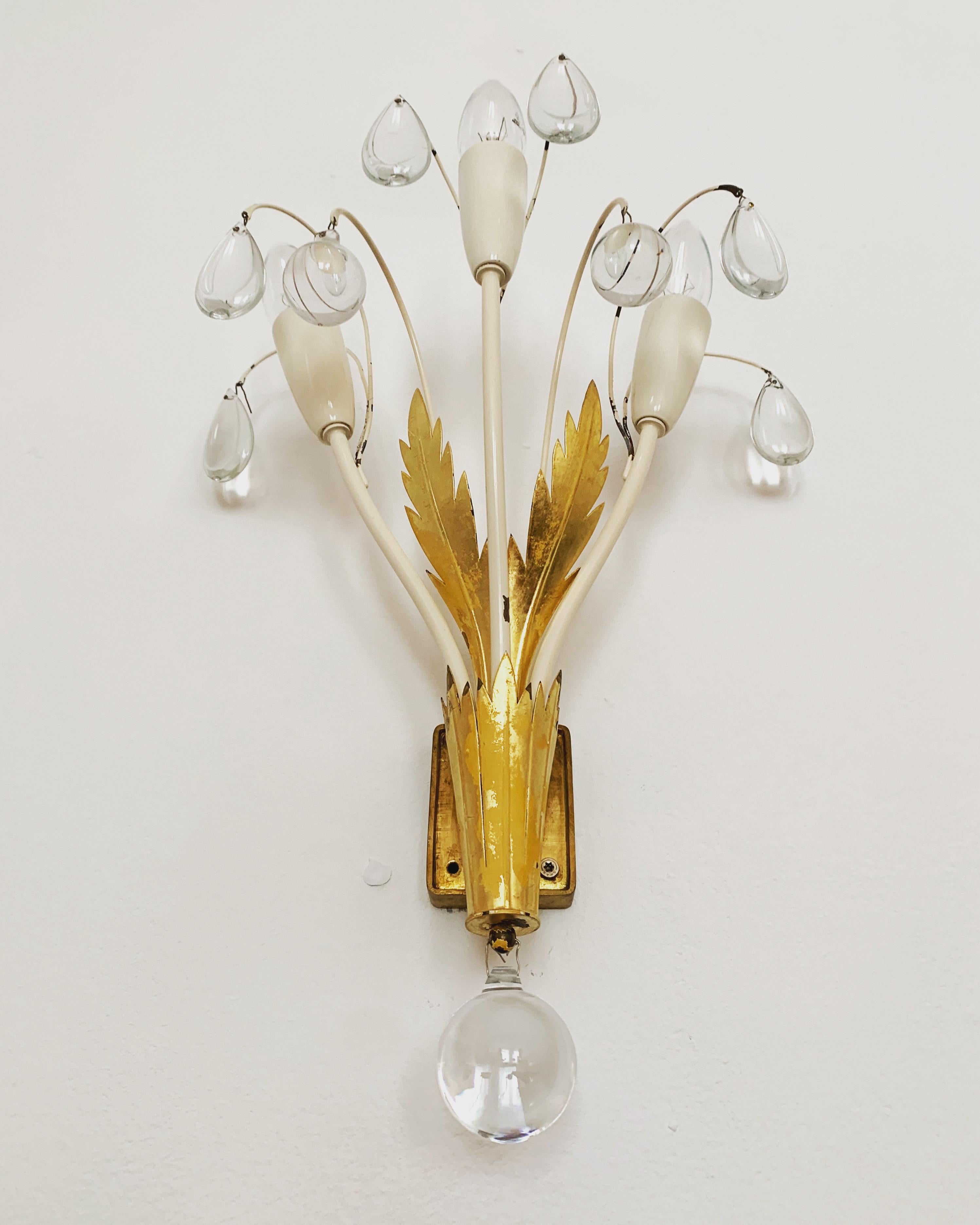 Extremely beautiful wall lamps from the 1950s.
The high-quality workmanship and the very noble material impress at first sight.
Exceptionally beautiful design.
The sparkling stones spread a sensational light.

Manufacturer: Vereinigte Werkstätten