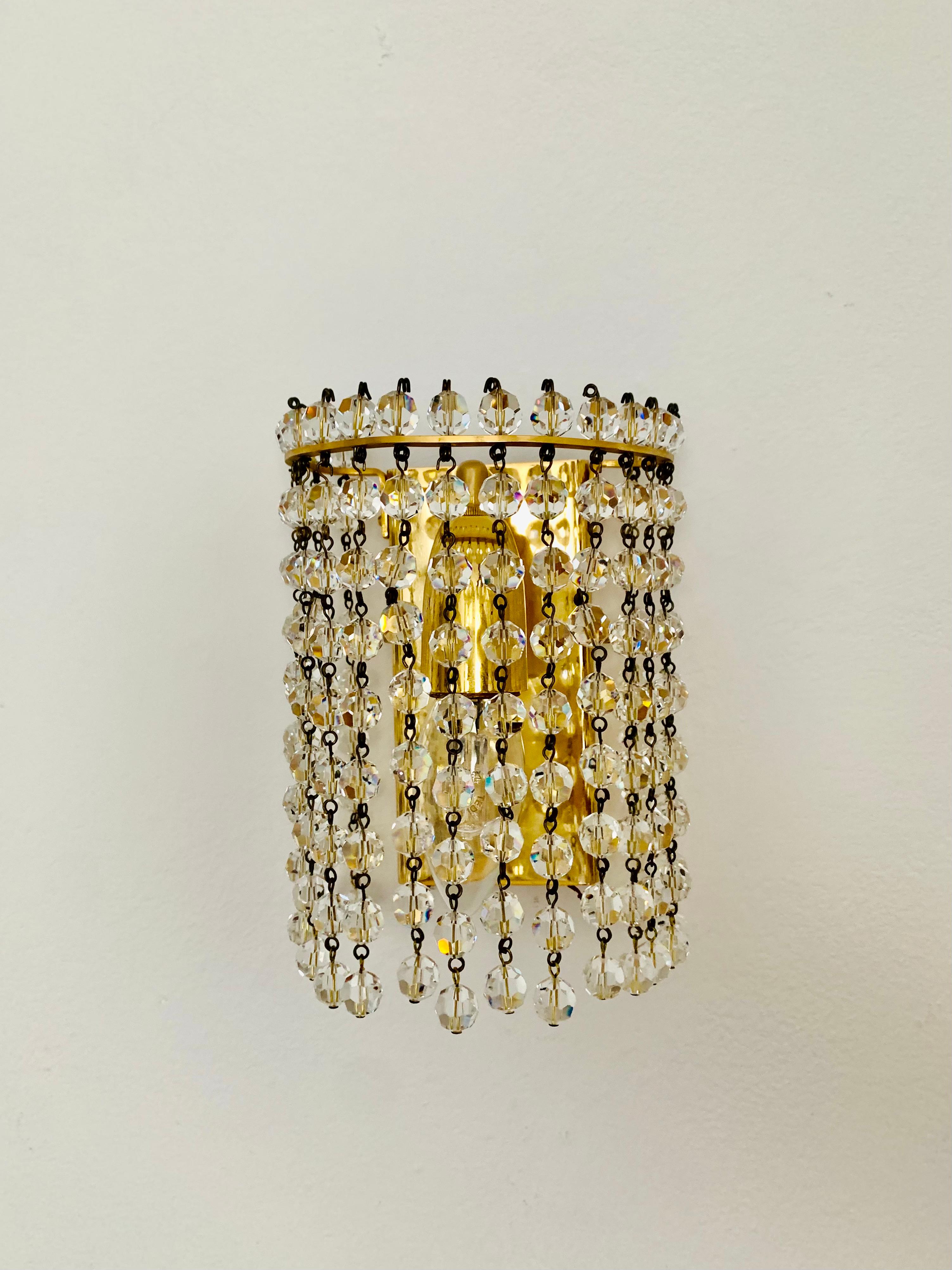 Very beautiful and rare wall lamps from the 1960s.
Very pleasant lighting effect due to the crystal glass, which spreads an elegant, sparkling play of light in the room.
Excitingly beautiful design and high-quality workmanship.

Manufacturer: