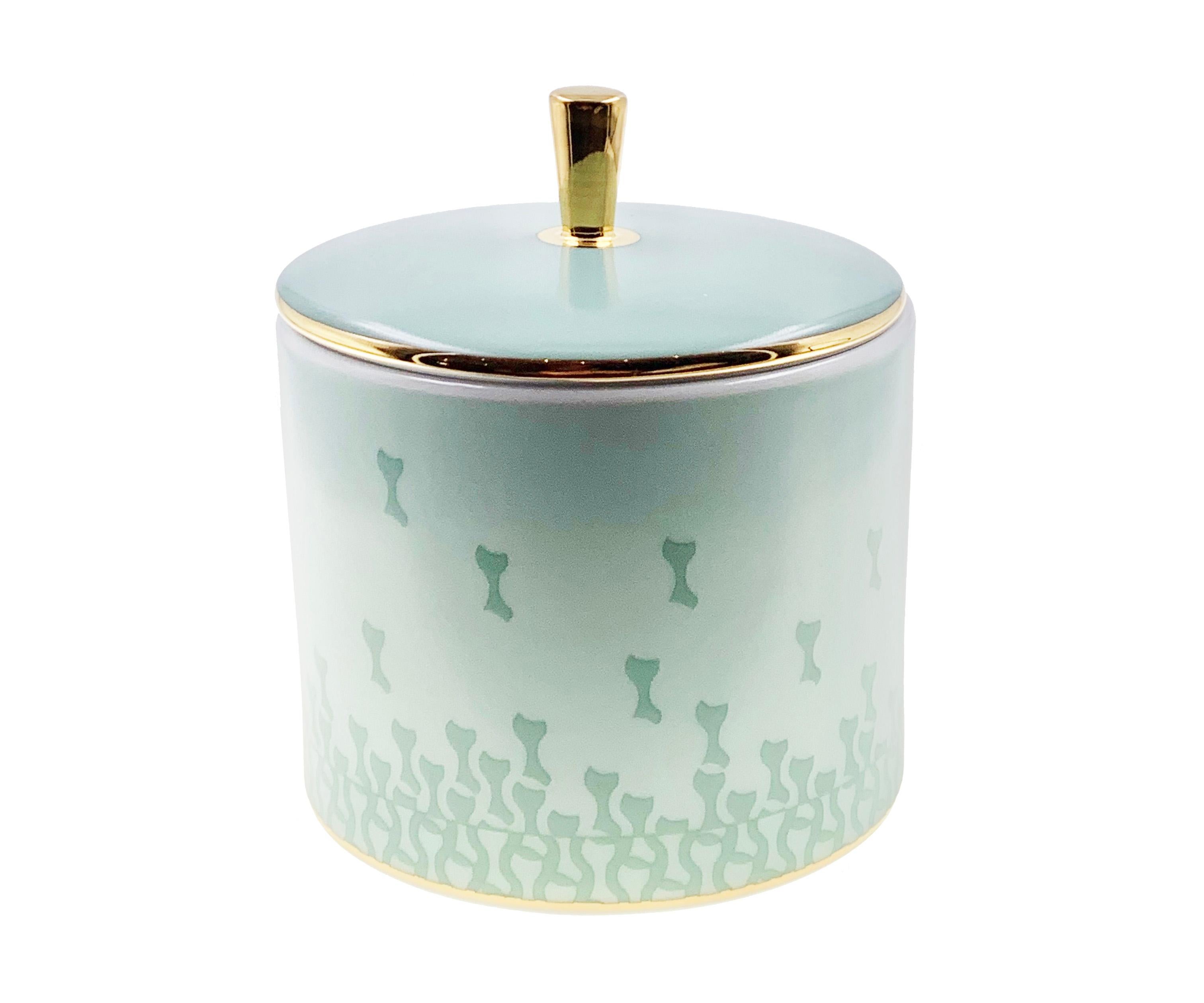 Larger quantities available upon request, with 8 weeks production time.

Description: Cylindrical box with lid (2 pieces)
Color: Sage green
Size: 8.5Ø x 7H cm, 80 ml
Material: Porcelain and gold
Collection: Mid Century Rhythm