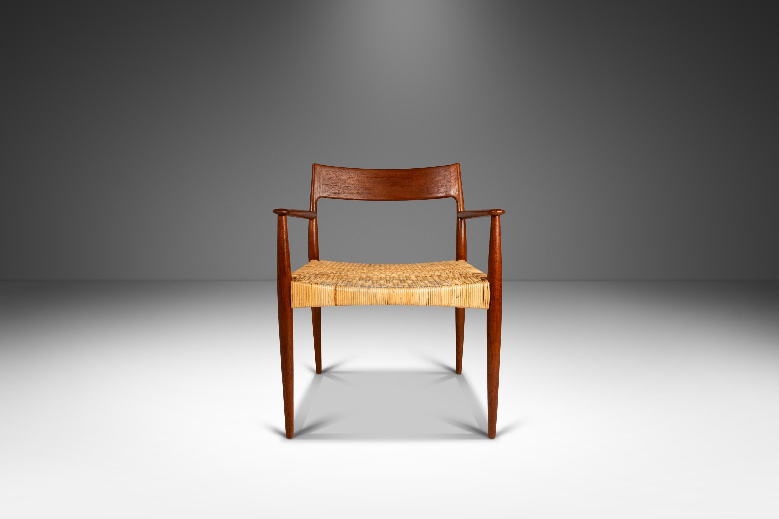 Introducing a rare and limited set of two (2) early Danish Modern arm chairs by Enjar Larsen & Aksel Bender Madsen for Willy Beck, crafted in the 1950s in Denmark. These stunning chairs are constructed from solid teak, showcasing the natural beauty