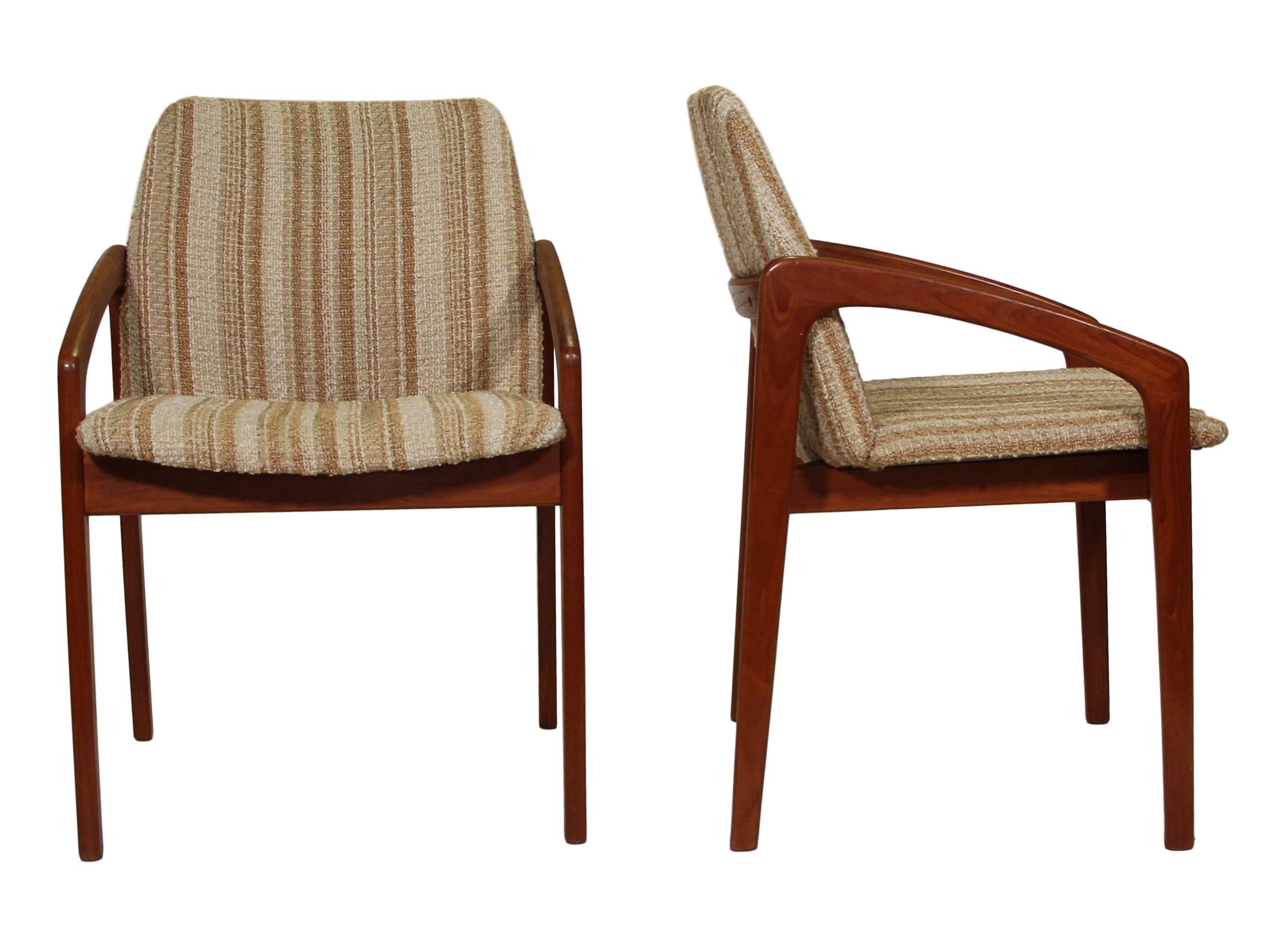 Pair of midcentury teak chairs by Kai Kristiansen. Made in Denmark. They have a unique frame design. The cream and brown striped fabric is original. 

The chairs are in very good vintage condition. One chair has two legs that have a scratch on