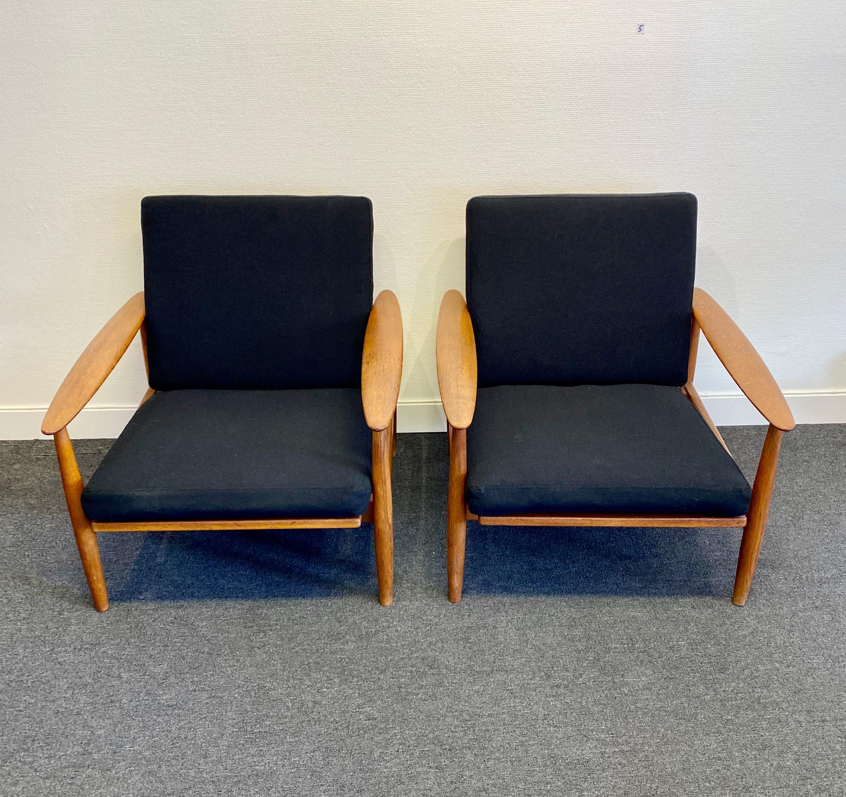 A set of 2 lounge chairs made in Denmark. Teak. Marked BM 8 with a red stamp underneath. New quality woolen fabric upholstery. Excellent vintage condition.