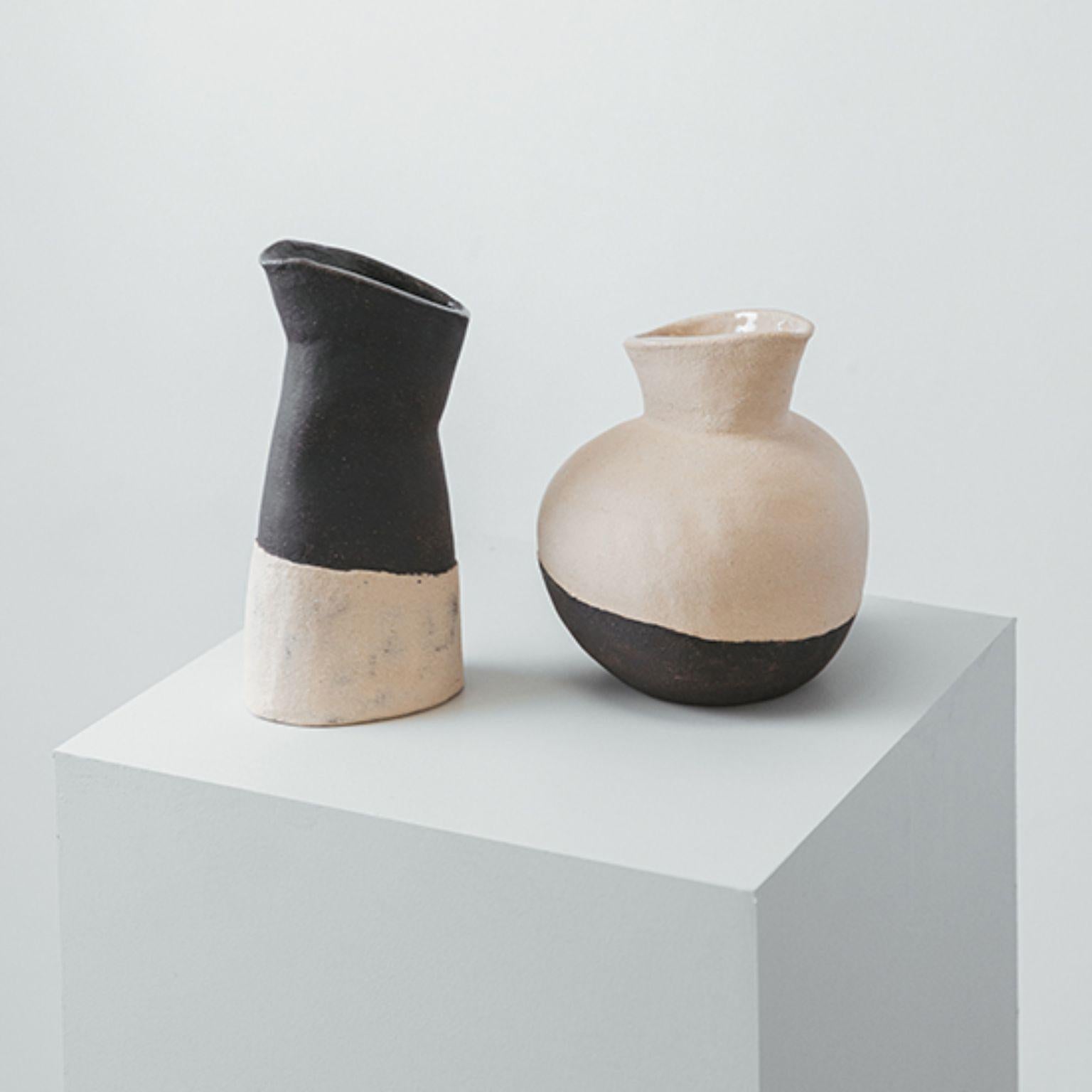 Set of 2 Deméter and Perséfone Wine and Water Jars by Cuit Studio
One of a Kind.
Dimensions: Deméter: Ø 16 x H 22 cm.
Perséfone: D 8 x W 12 x H 24 cm.
Materials: Natural and black stoneware.

Sculptural water & wine jar set. Mix of natural and black