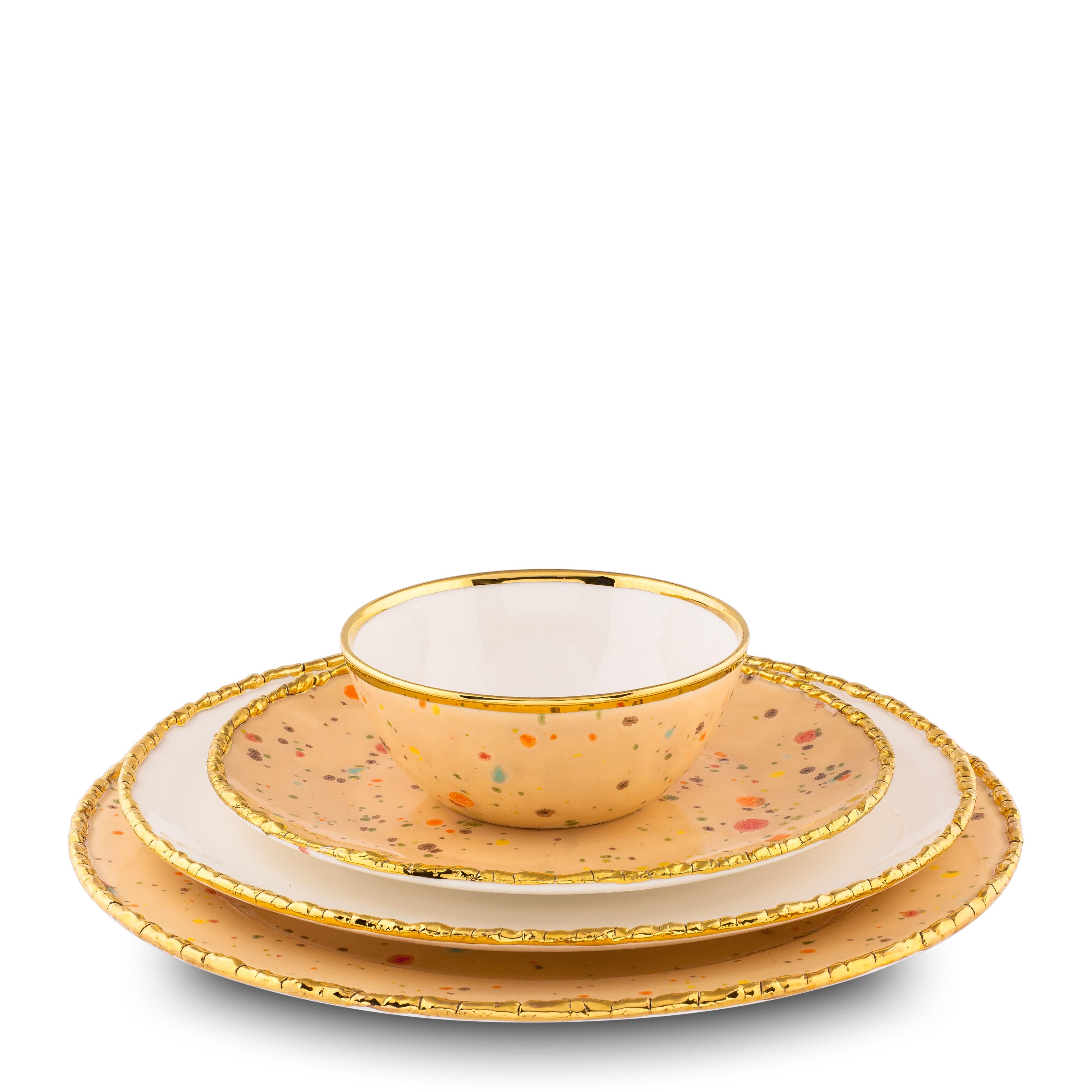 Handcrafted in Italy from the finest porcelain, these Craquelé edge dessert coupe plates from the Chestnut Collection. The original golden crackled edge emphasizes the warm sandy surface covered with little multicolor dots and the bright yellow