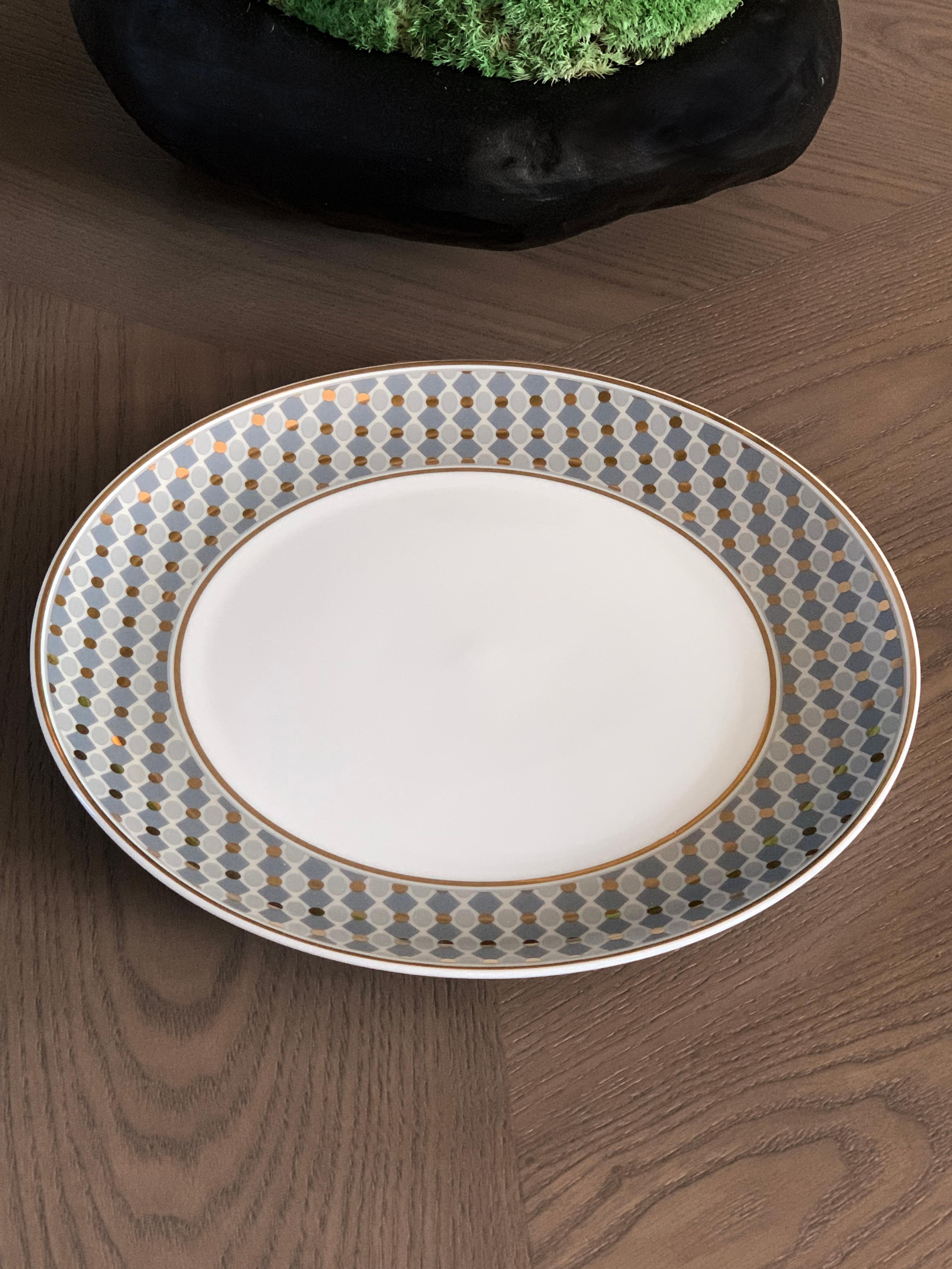 Larger quantities available upon request, with 8 weeks production time.

Description: Dinner plate ring pattern (2 pieces)
Color: Blue and gold
Size: 26.5 Ø x 2.5 H cm
Material: Porcelain and gold
Collection: Modern Vintage