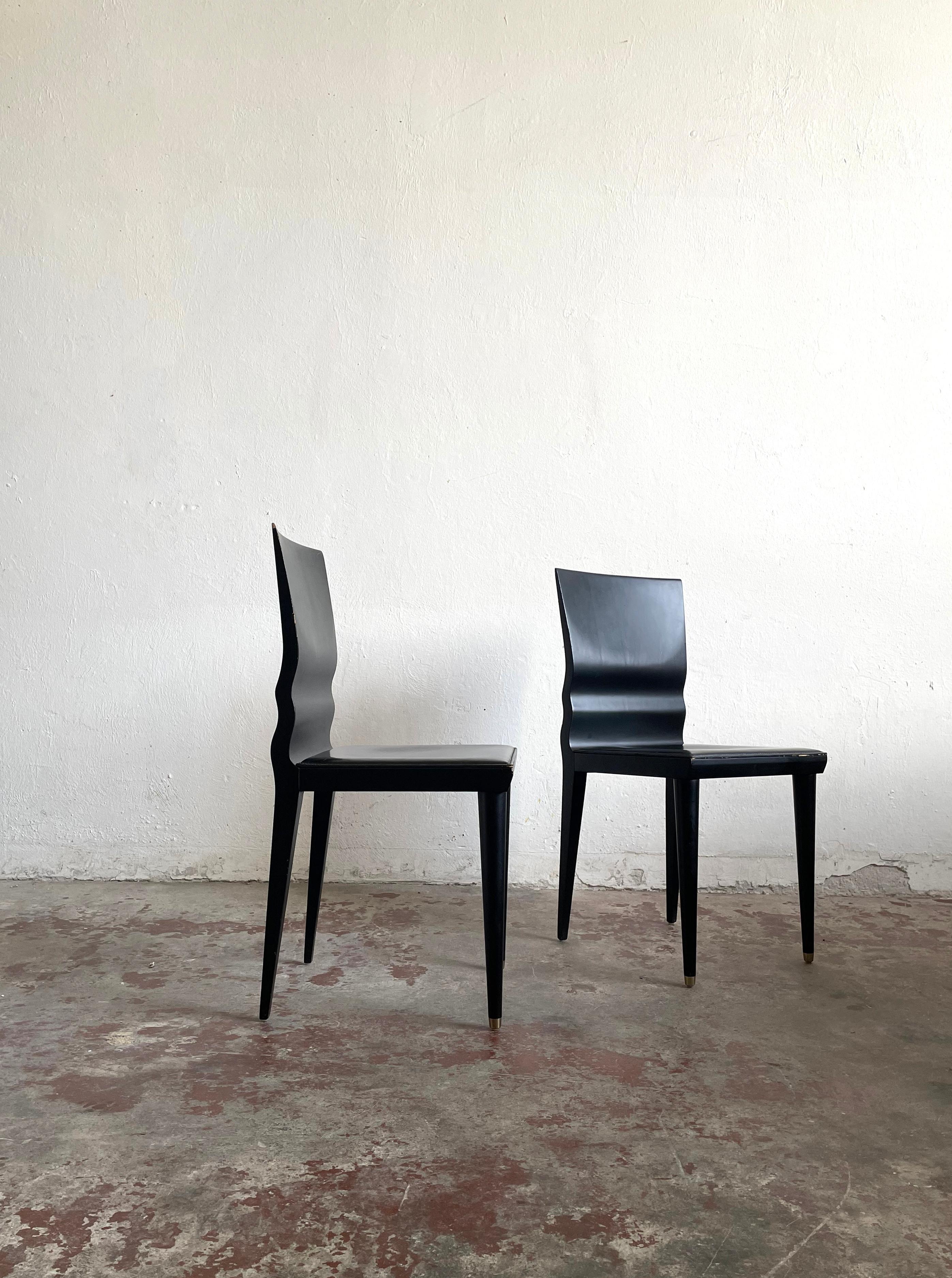 Two ebonized wood chairs with black leather padded seats, model 'Diva', designed in 1987 by William Sawaya for Sawaya & Moroni 

The chairs were in production during the late 1980s and 1990s 

The chairs have some traces of wear shown on the