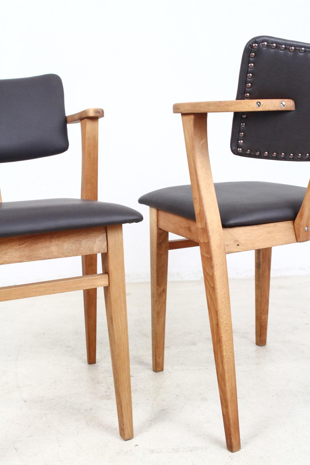 This model Domus armchair was designed by Ilmari Topiovaara and has been completely restored and reupholstered with dark brown faux leather. The scale of the design and the unique design of the arms makes it a great desk chair or occasional chair.
