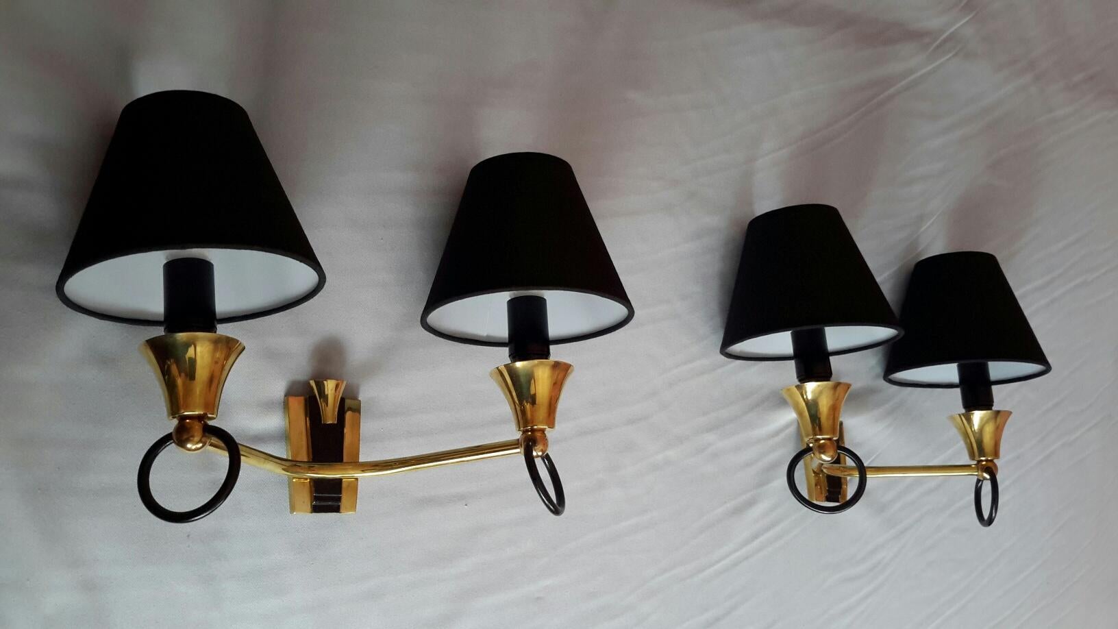Very stylish set of two pairs of French neoclassical two-light sconces of the 1950s, in bronze black lacquered and brass with black cotton lampshade in the style of Maison Jansen.
The 4 double sconces are in excellent condition, they have been