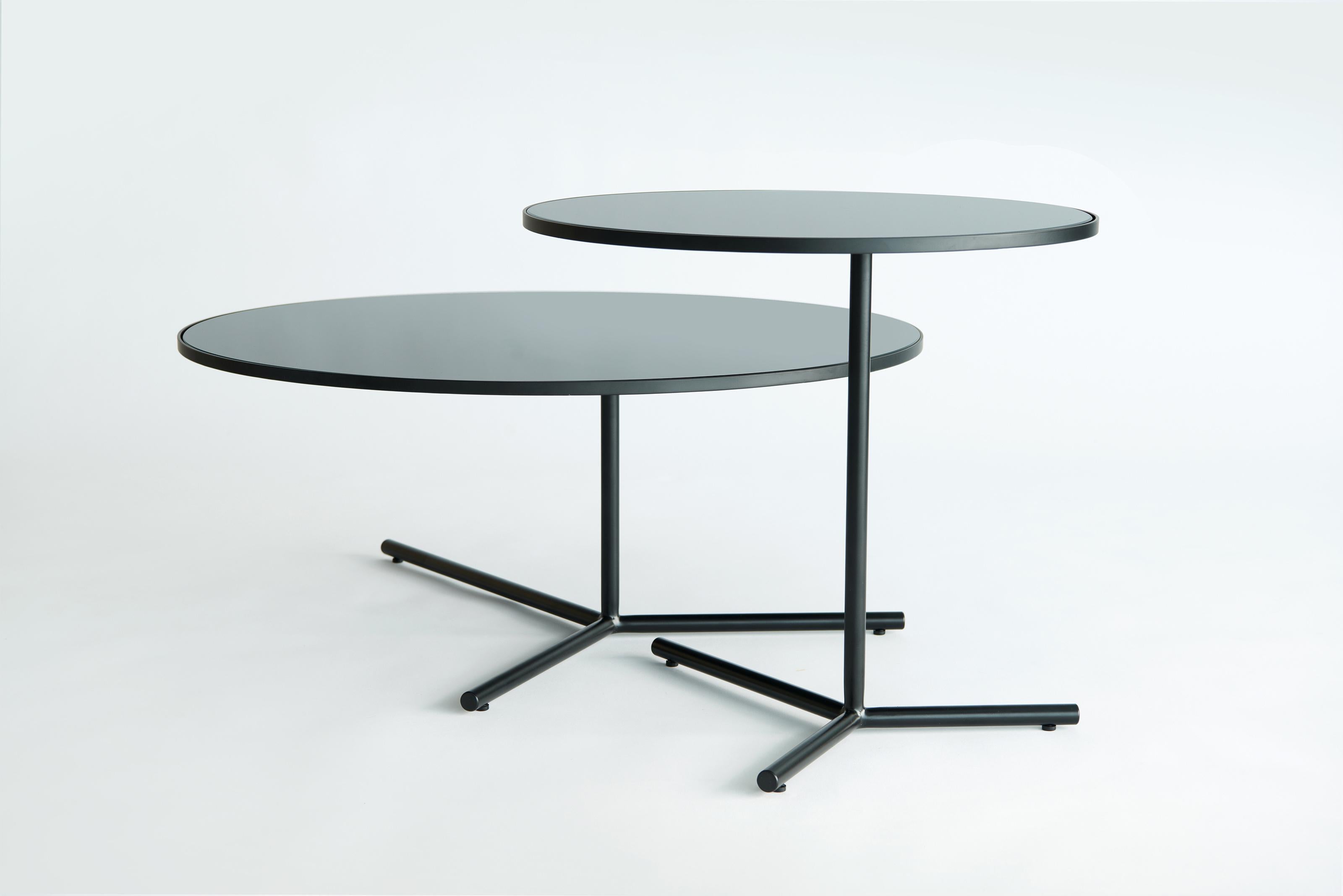 Set Of 2 Downtown Tables by Phase Design
Dimensions: Large: Ø 76,2 x H 30,5 cm. 
Medium: Ø 50,8 x H 45,7 cm. 
Materials: Spandrel glass and powder-coated steel.

Solid steel base available in flat or gloss black and white powder coat, polished