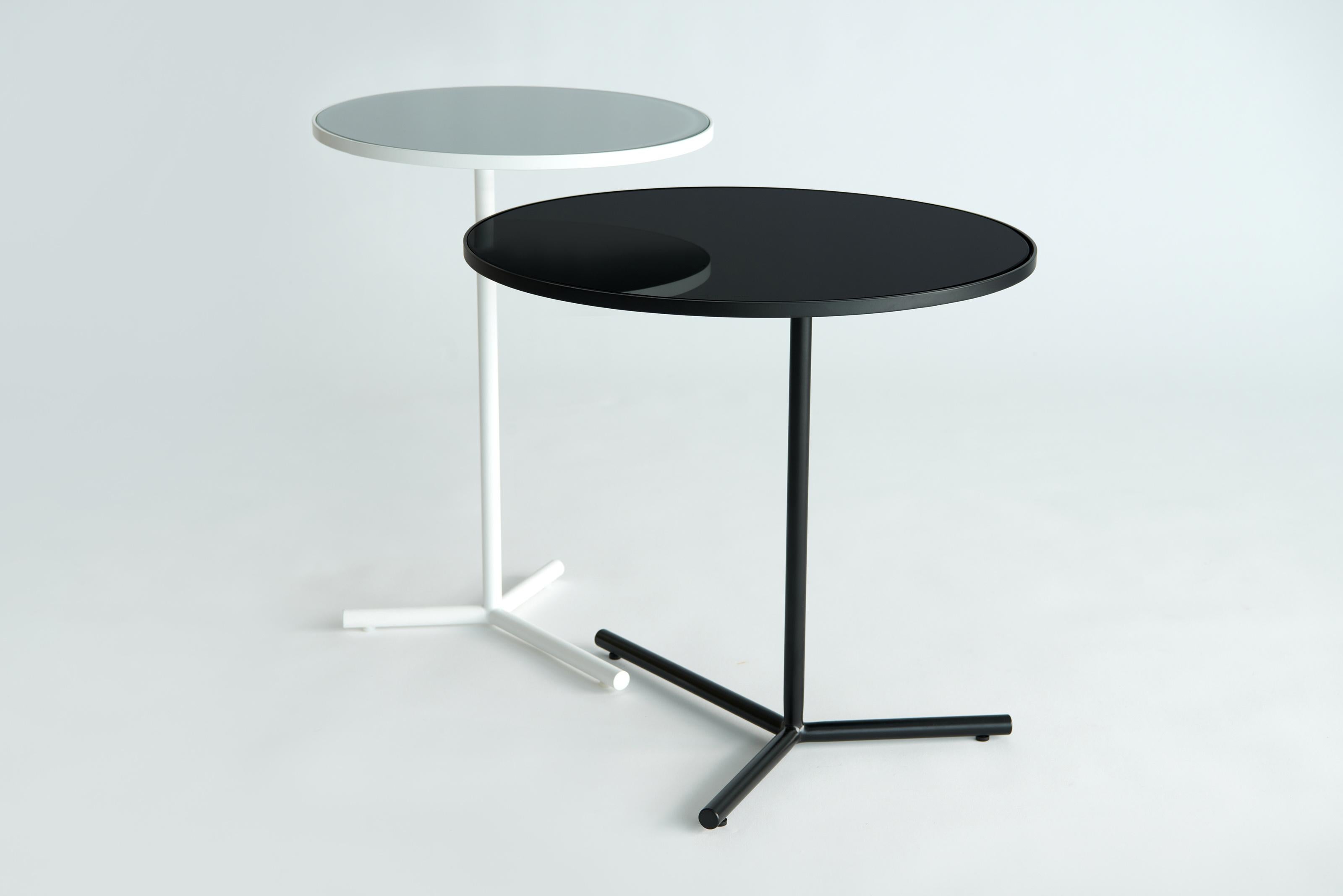 Set Of 2 Downtown Tables by Phase Design
Dimensions: Medium: Ø 50,8 x H 45,7 cm. 
Small: Ø 38,1 x H 53,34 cm.
Materials: Spandrel glass and powder-coated steel.

Solid steel base available in flat or gloss black and white powder coat, polished