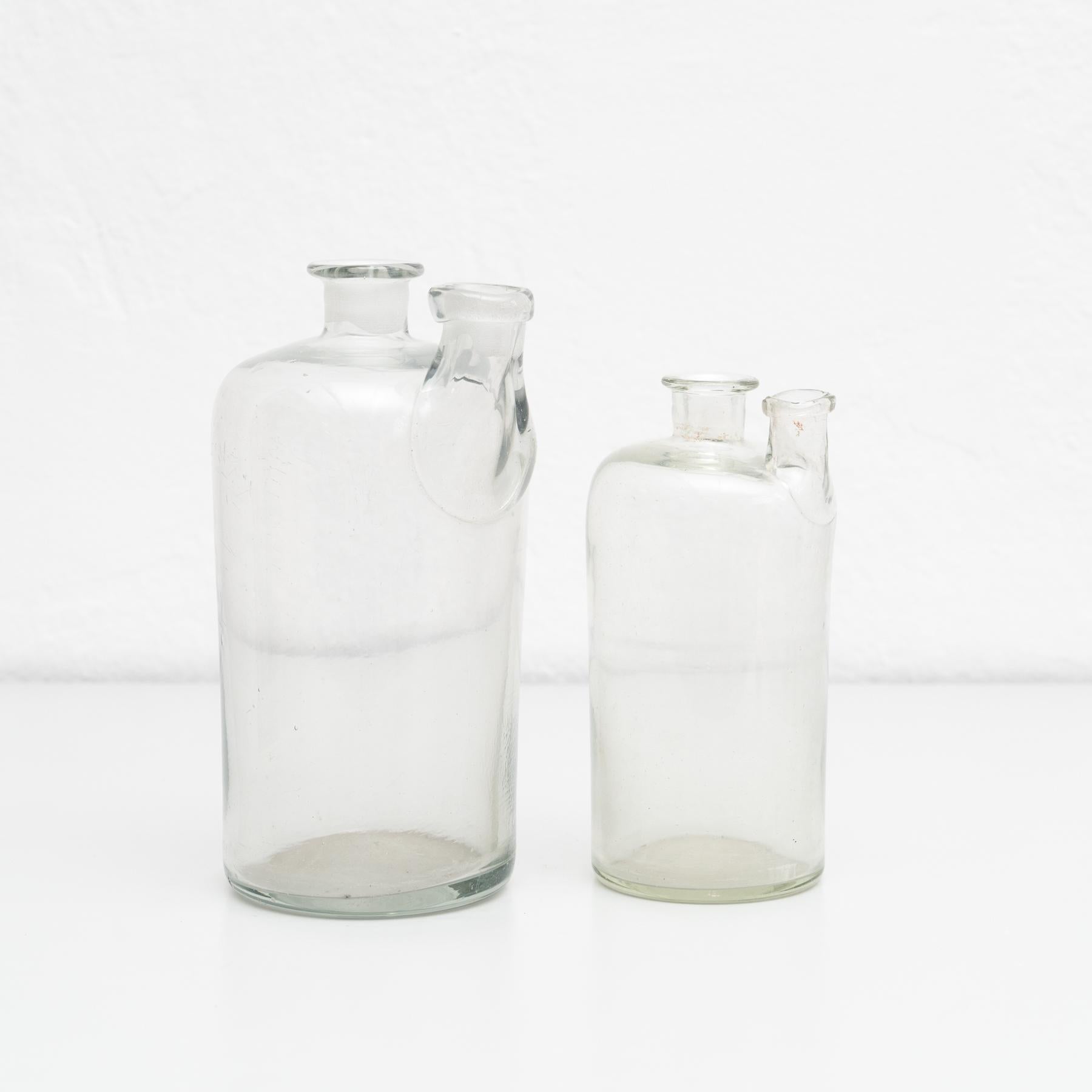 Set of 2 early 20th century glass bottles.

By unknown manufacturer, Spain.

In original condition, with minor wear consistent with age and use, preserving a beautiful patina.

Materials:
Glass.
 