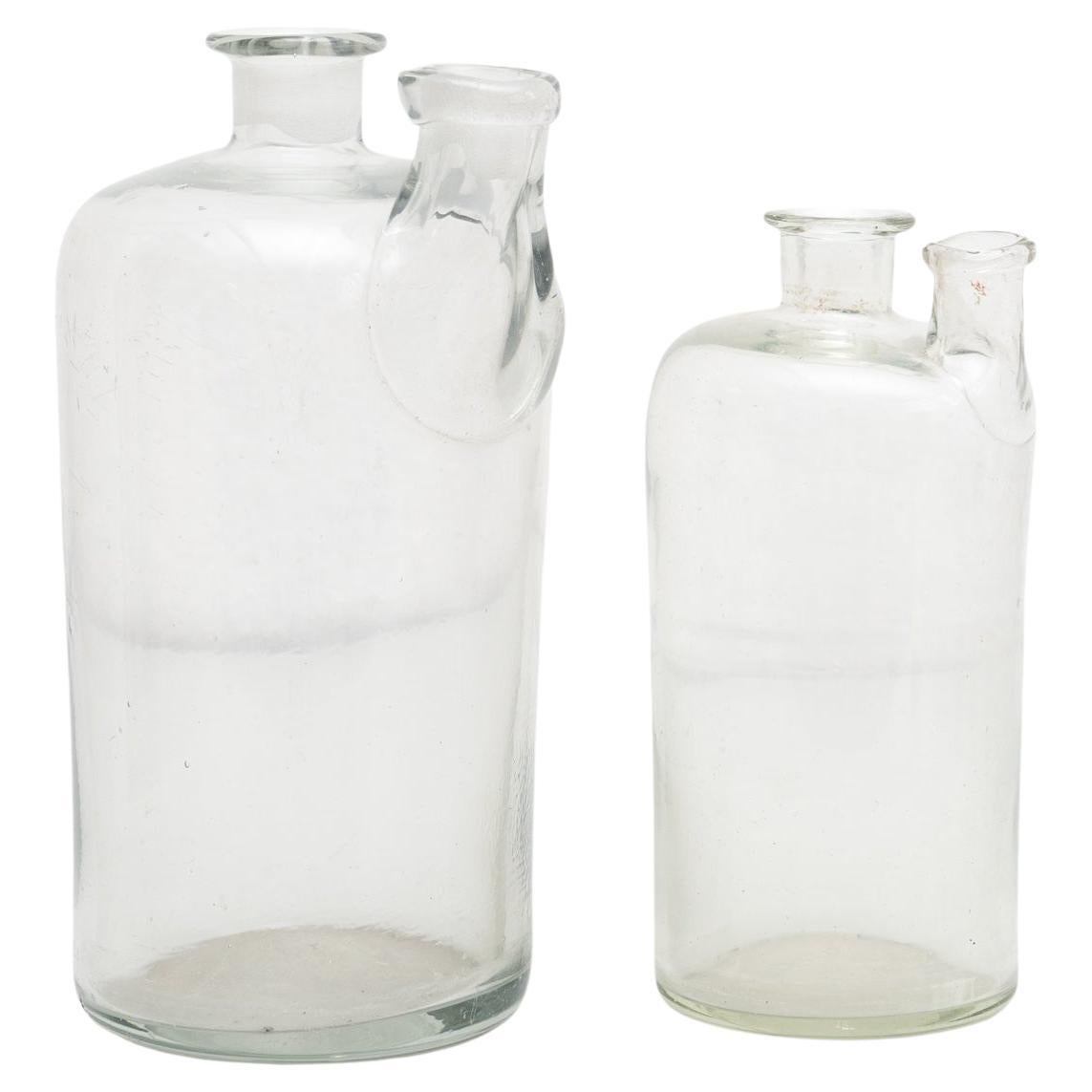 Set of 2 Early 20th Century Rustic Glass Bottles For Sale