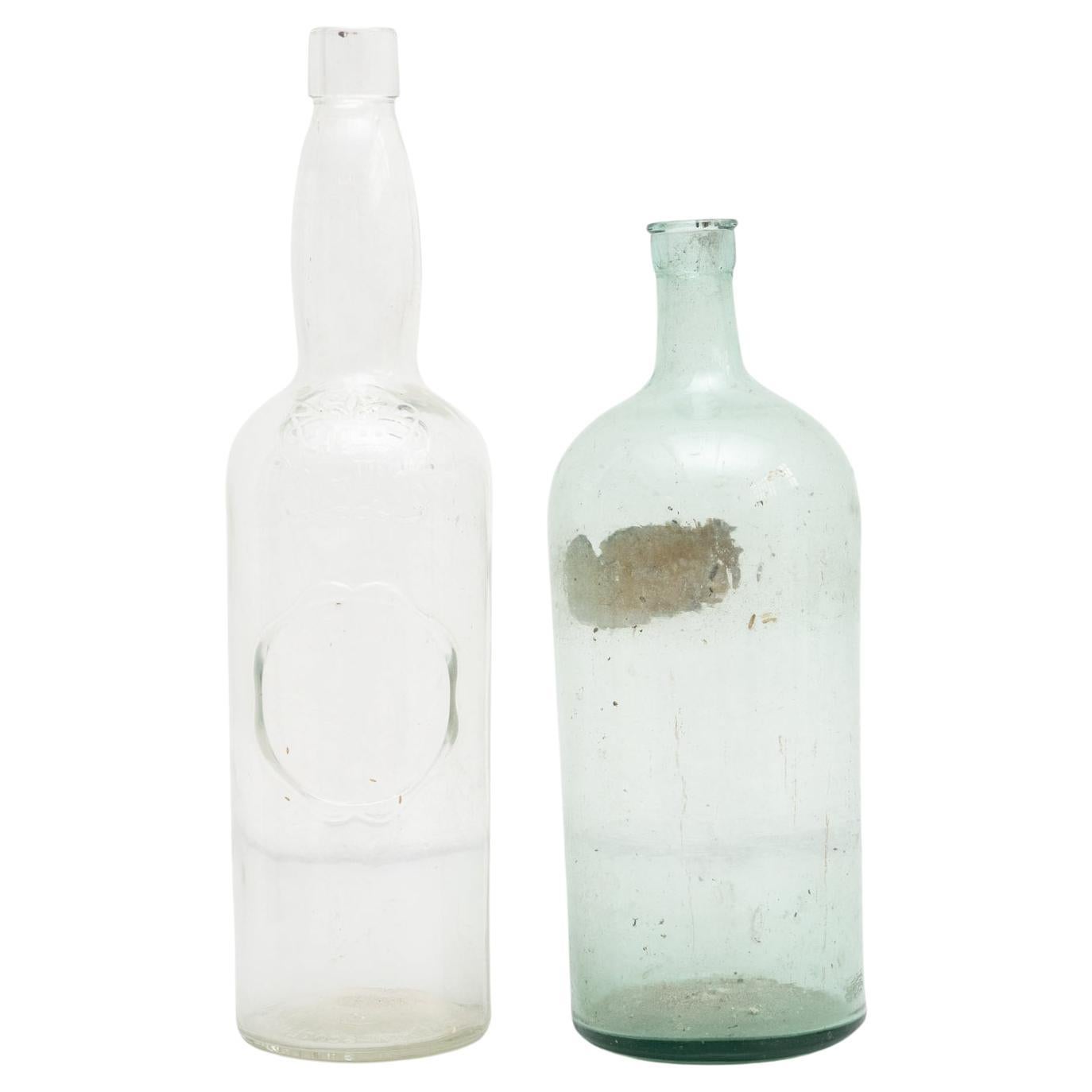 Set of 2 Early 20th Century Rustic Glass Bottles For Sale