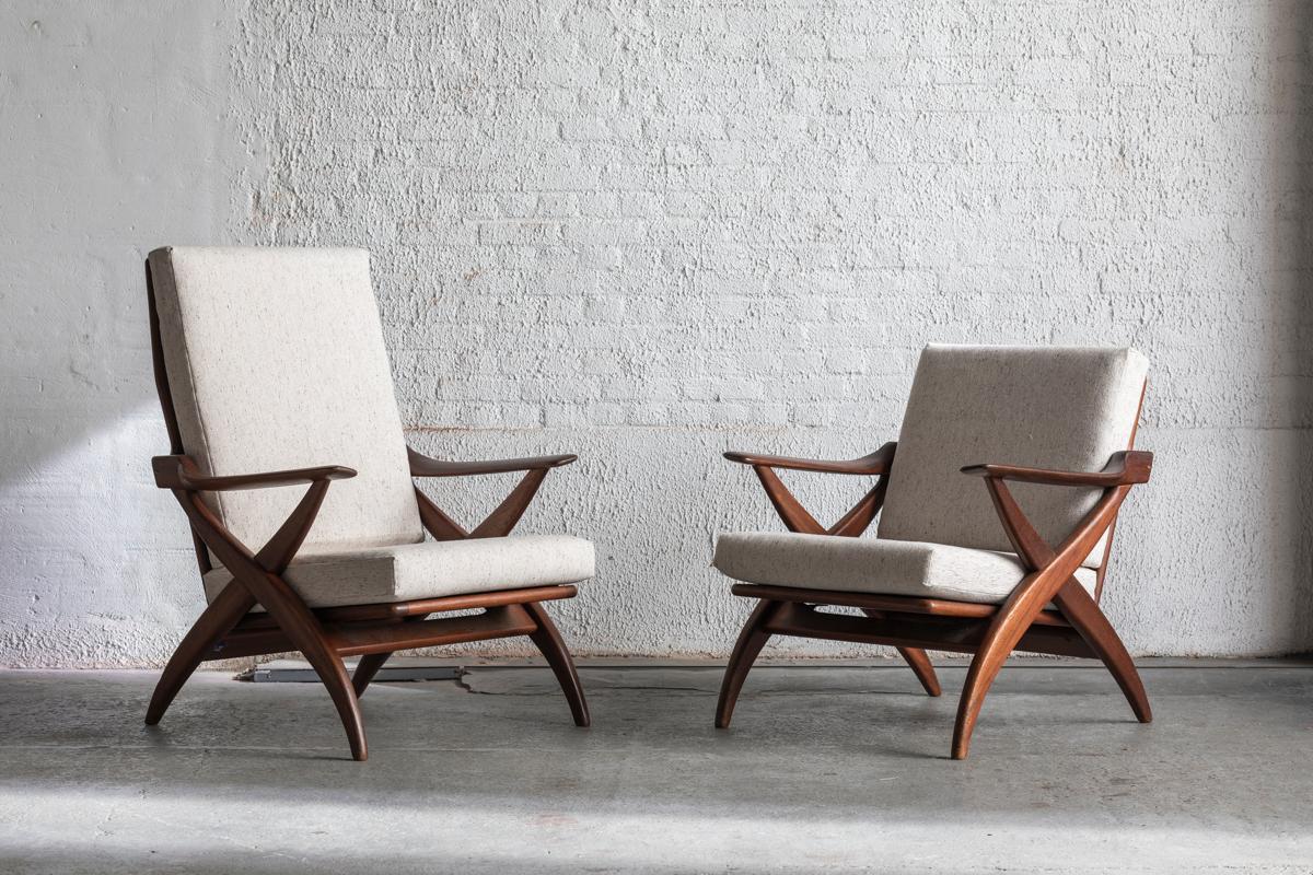 Two easy chairs produced by Topform in the Netherlands around 1960. This set features one highback and one lowback seater. Solid, organically shaped frame in teak and newly upholstered cushions in speckled beige. In very good condition. Original
