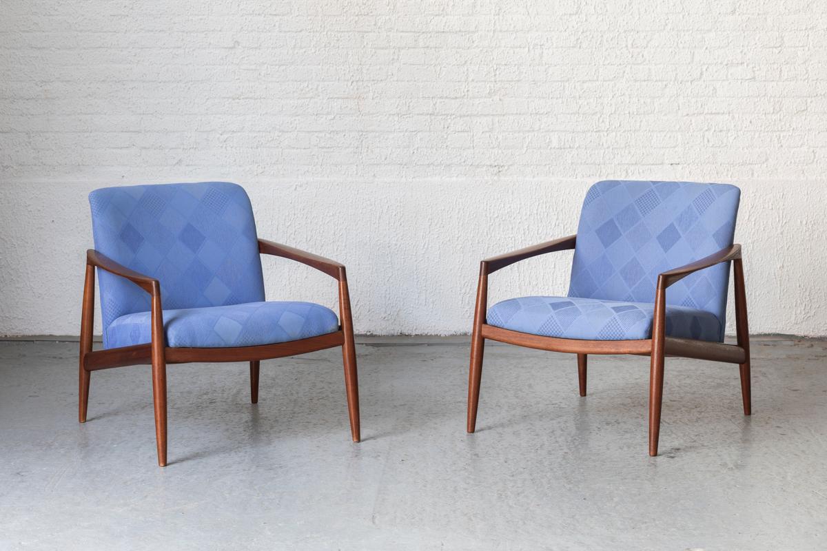 Set of easy chairs designed in the style of Kai Kristiansen, Danish design from the 1960’s. Solid teak wooden frame, upholstered in a blue fabric with a square design pattern. In very good condition with some using marks as shown in the