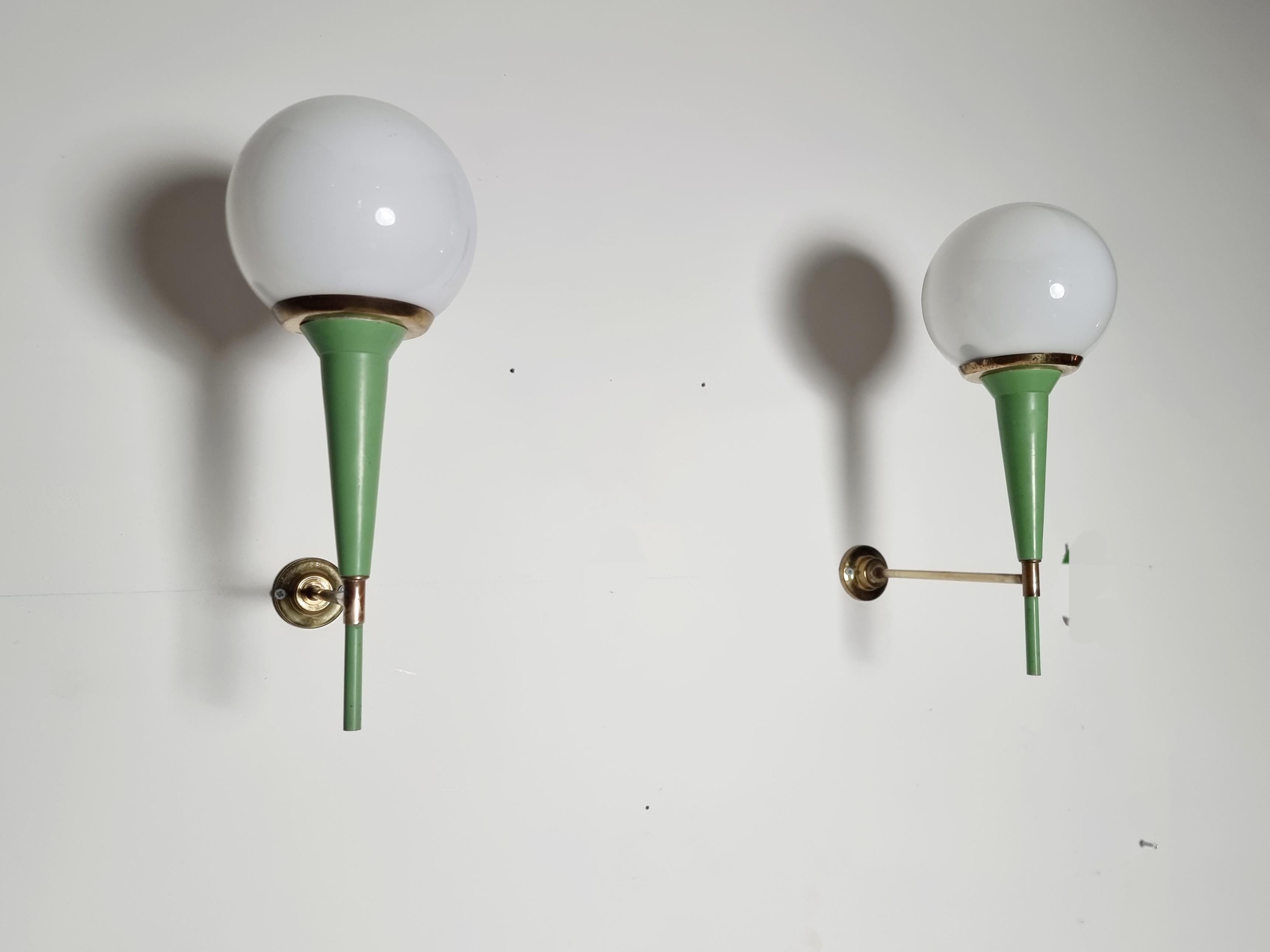 Very elegant pair of French wall lights. Made of brass and enamel with an opaline glass light bulb. Fantastic patina and in working condition.