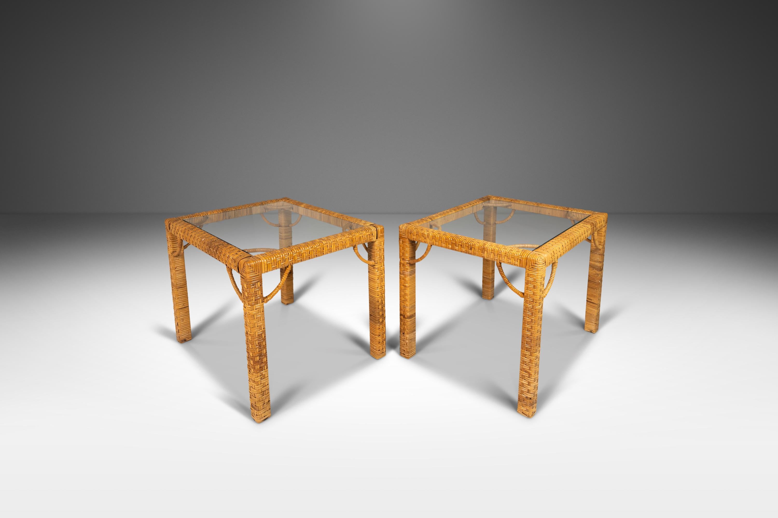 Offered for your consideration a set of two (2) Mid Century Modern End Tables that exude boho chic and bohemian vibes. These stunning pieces, attributed to Bieckley Brothers Rattan, are constructed with a cane wrapped design that is both