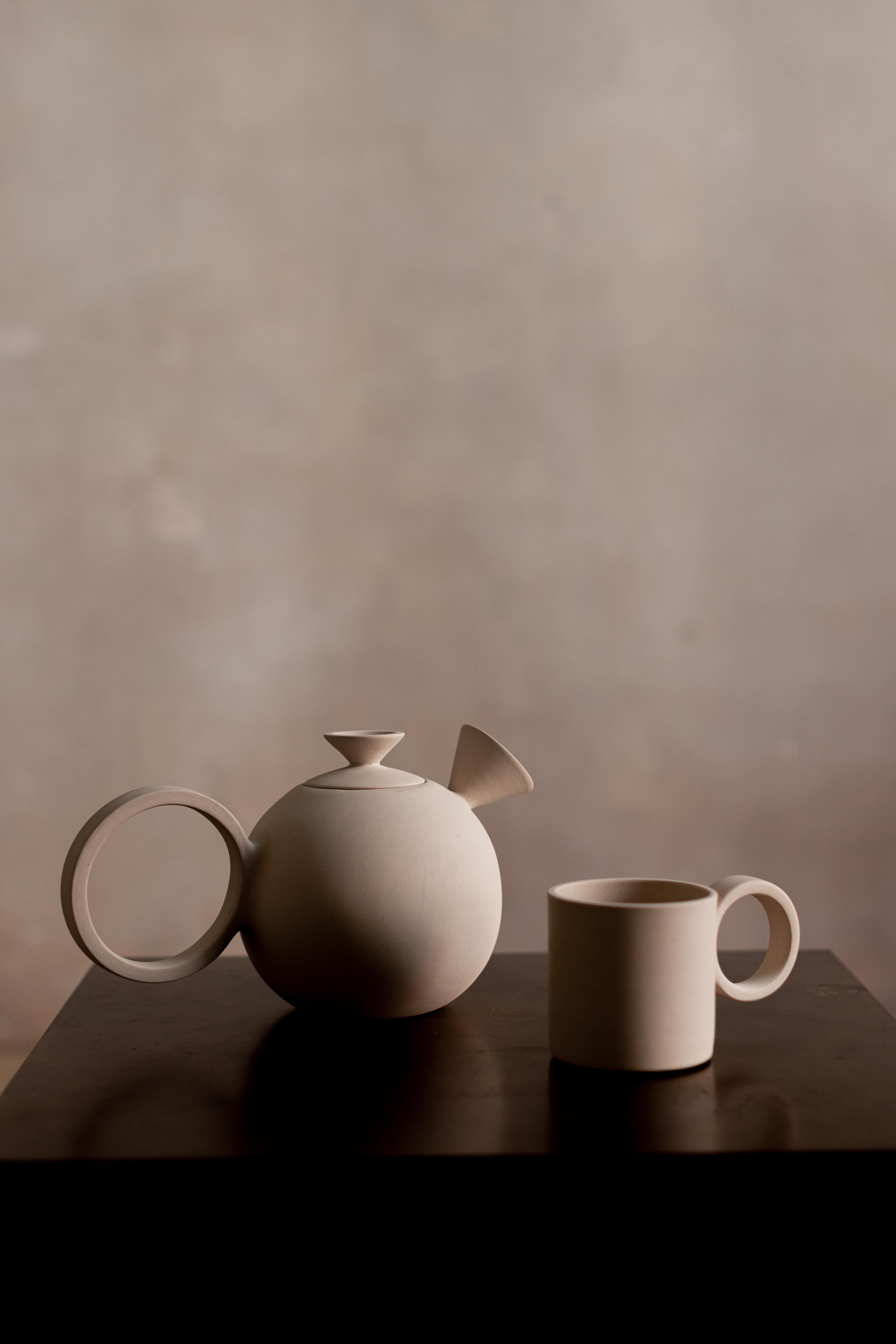 Set of 2 Euclid Teapot and Mug by Eter Design
Unique Piece.
Dimensions: Teapot: D 16 x W 28 x H 16 cm.
Mug: Ø 9 cm x H 9 cm.
Materials: Clay.
Sustainable - Eco-friendly. Handmade. Each piece may vary slightly in color, Size, texture and shape.